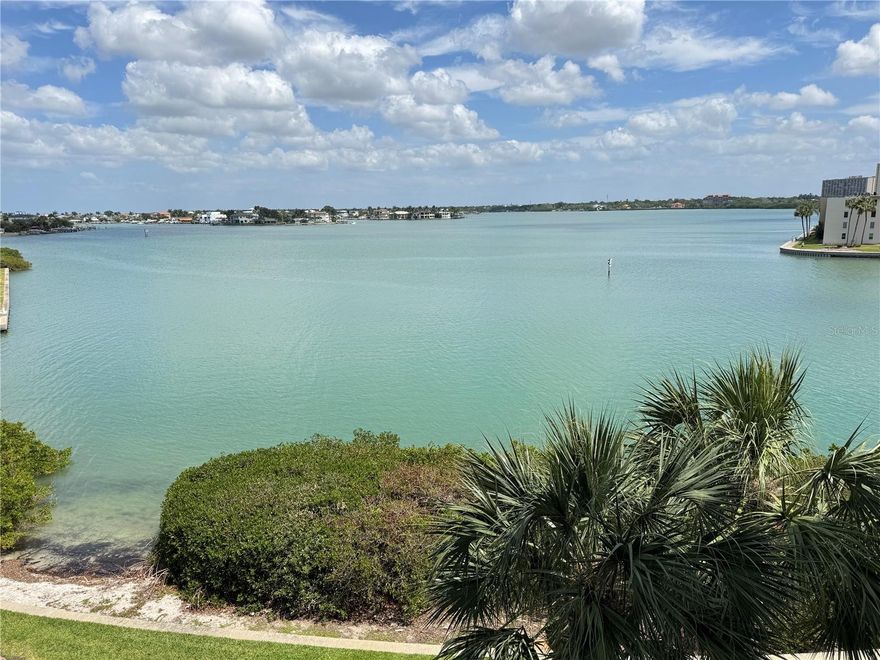 Welcome to Sunrise at Harbourside! 
Experience waterfront living at its finest in this stunning 3rd-floor, 2-bedroom, 2-bathroom condo overlooking the serene Boca Ciega Bay. This unit perfectly blends peace of mind with an active resort lifestyle, featuring brand-new high-impact windows and sliding glass doors that frame beautiful water views from your private balcony. The interior is finished with sleek, uniform tile flooring throughout. Practical updates include a 2016 hot water heater and a 2009 AC system. For added convenience, the unit comes with a dedicated under-building parking space (#107), keeping your vehicle cool and protected. There are two storage units, one on the balcony and the other near the elevator. Located in a premier island community, the amenities are unmatched: A scenic 1.5-mile walking trail encircles the island, complemented by 5 tennis courts and a dedicated pickleball courts. Choose from 6 swimming pools, unwind in the hot tubs or sauna, and stay active in multiple on-site gyms. When Constructing Harbourside, JMC the contractor used Solid Steel reinforced concrete construction rather than hollow concrete blocks. Amenities include 6 swimming pools, 5 tennis courts with Pickle ball courts, 2 fitness centers, Men and Women's Gyms, Jacuzzi, saunas, shuffleboard, multiple outdoor gas grills, Wood Working shop, Library, Card Room, Billiard room, 3 car wash station with vacuum & air, 4 Car Charging stations, Marina with 3 docks and 87 deeded slips. There is no deeded slip to this unit but there are slips available to rent or purchase from other owners. A Clubhouse with a full social agenda and a 1.5 mile walking trail around the island to exercise or walk your pet. Sun Rise allows owners one pet under 20 pounds. Come and enjoy Resort style living at it's best. Whether you're looking for a year-round residence or a vacation getaway, this condo offers the perfect coastal retreat. Furniture and furnishing's include