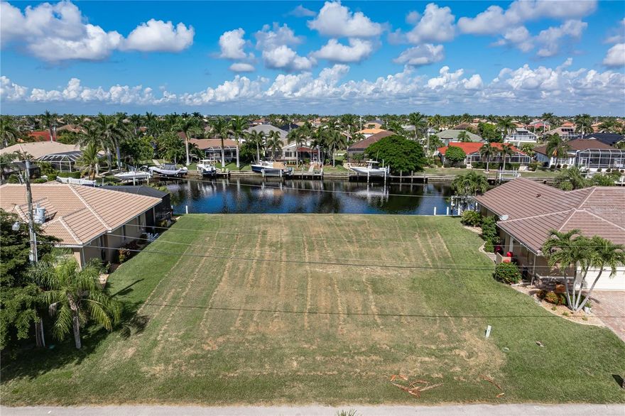 VACANT, WATERFRONT LOT IN BURNT STORE ISLES - This oversized, waterfront property features 93 ft of seawall and sail access to Charlotte Harbor. Lot is located on a quiet street & is surrounded by beautiful, custom-built homes. Build your dream home here and take advantage of the wide canal view and boating access through the recently widened channel into Alligator Creek. Start enjoying some of the best fishing & boating in SW Florida directly from your backyard. Burnt Store Isles is a deed-restricted, waterfront & golf community w/a voluntary HOA. HOA & resident-only boat club host social events & community activities throughout the year. They are a great way to meet your neighbors & stay connected throughout the year.  Enjoy boating from your backyard & golf right around the corner. Twin Isles Country Club is located in the center of the community. Practice your short & long game, brush up on your tennis strokes or simply enjoy the social setting. Burnt Store Marketplace anchors BSI offering a Publix, Home Depot & several other shops & restaurants. Get all our shopping done without leaving the neighborhood! Easy access to US41, I-75 & Burnt Store Rd allow you to reach Ft Myers, Cape Coral & Sarasota effortlessly. Take advantage of the active lifestyle available here in Punta Gorda by enjoying the numerous walking & biking trails as well as the many waterfront parks offering everything from playgrounds to pickleball courts. Claim your spot in paradise.