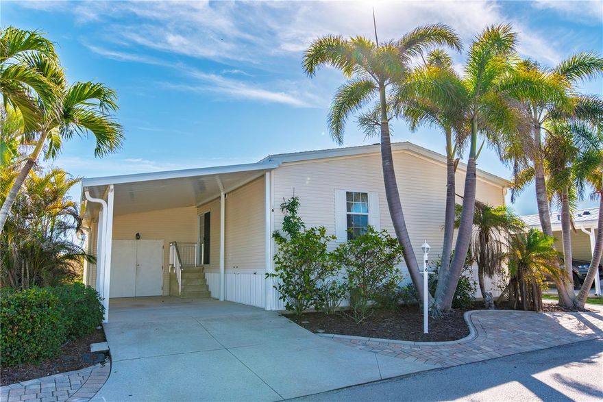 Under contract-accepting backup offers. Nestled in the sought-after 55+ community of Windmill Village, this waterfront gem is a true diamond in the rough, offering serene views overlooking Alligator Creek. This 2005 Champion model home features 1,193 square feet of thoughtfully designed living space, including 2 bedrooms and 2 bathrooms. The open-concept layout highlights a spacious kitchen with ample storage, dual sinks, and seamless flow into the living and dining areas. Step outside to the lanai and enjoy peaceful water views or head to the 7x15 composite dock to fully embrace waterfront living. The home is built with a concrete sill around the base for added durability. A carport accommodates two cars, while additional parking is available on the paver area next to the house, offering convenience for guests or extra vehicles. With its prime location, charming features, and room for personalized updates, this home provides a wonderful opportunity to create your dream retreat in this welcoming, active community. Plus, the HOA of $230.00 covers water, sewer, trash, grass maintenance, common area upkeep, and road maintenance, ensuring a hassle-free lifestyle for residents. Don't miss your chance to experience the comfort and convenience of waterfront living in this meticulously maintained home at Windmill Village!  This active lifestyle community features two private marinas, boat ramp, trailer storage yard, horseshoe pits, shuffleboard, bocce ball, billiards, indoor pickleball, a large community center and many clubs catering to your hobby interests. The Pavilion by the heated pool offers an area for holding gatherings. Punta Gorda was voted “#1 Best Small Place to Live” by Money Magazine and Forbes. Purchase price does not include $20,285 for Buy-In Share and Bond, which is refunded when you sell. Don't miss the opportunity to make this thoughtfully upgraded and beautifully maintained home in Windmill Village yours! Schedule your showing today-this is your paradise.