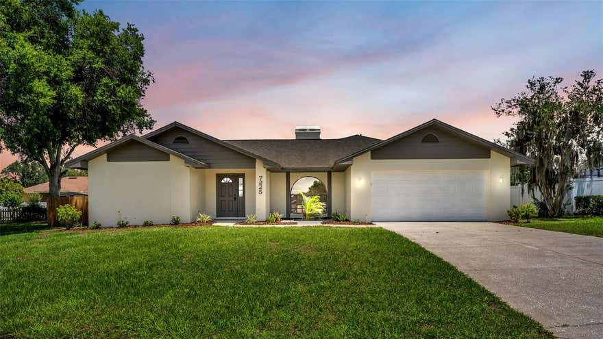 One or more photo(s) has been virtually staged. Welcome to 7225 Hileman Dr E, a beautifully updated three-bedroom, two-bathroom home offering 2,355 square feet under roof and situated on an oversized .35-acre lot in Lakeland Florida.  This property truly stands out with its expansive fenced backyard — a rare outdoor retreat offering endless possibilities for entertaining, gardening, pets, play, or even creating your own private backyard oasis. With mature surroundings and plenty of space to spread out, the yard becomes an extension of the home and a true highlight of the property.  Inside, the home welcomes you with fresh interior paint, new flooring throughout, updated baseboards, and new interior doors that create a clean and modern feel from room to room. The spacious layout flows effortlessly into the upgraded kitchen featuring stainless steel appliances, solid surface countertops, ample cabinetry, and functional workspace perfect for everyday living and entertaining. Just off the main entry area, the enclosed great room provides additional flexible living space with lots of natural light ideal for relaxing, hosting guests, or enjoying year-round Florida living.  The thoughtfully designed floor plan also includes a dedicated office space, perfect for working from home, hobbies, or a quiet retreat. The primary suite offers generous space along with his-and-her closets and a skylight in the en suite bathroom that fills the space with beautiful natural light. Additional highlights include an indoor laundry room, freshly painted garage floor, a brand-new air conditioner, and a newer roof for added peace of mind. Conveniently located near shopping, dining, parks, and all that Lakeland has to offer, this move-in-ready home combines privacy, modern updates, and exceptional outdoor living in one incredible package.