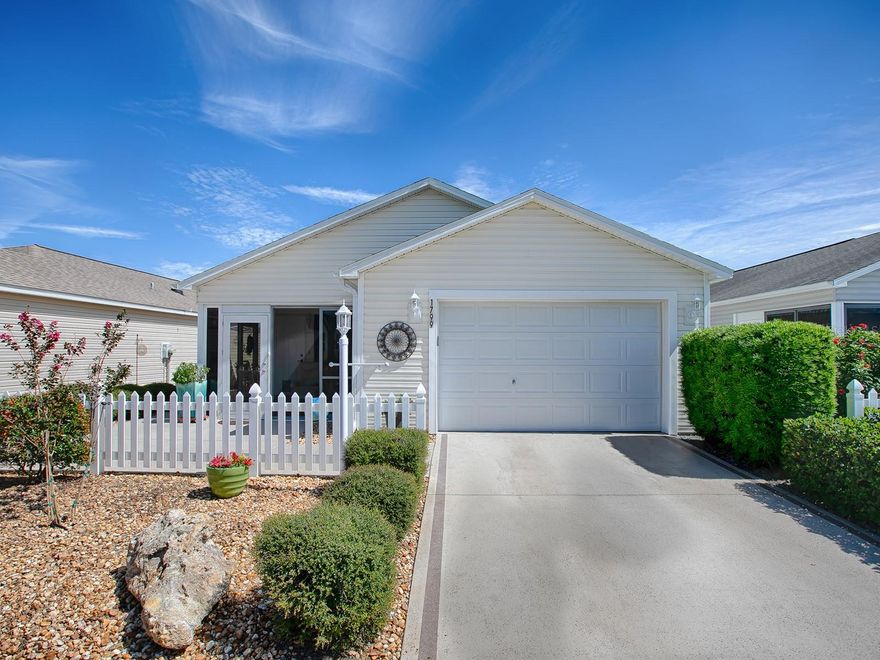 CHEERFUL 2/2 COLONY Patio Villa in the VILLAGE of BUTTONWOOD with NEWER ROOF 2020, LOW MAINTENANCE YARD with ENCLOSED LANAI and a side patio area for outdoor enjoyment. This home says "WELCOME" as you enter the ENCLOSED LANAI with TILE flooring.  
Step inside and notice the LOVELY WIDE-PLANK LUXURY VINYL flooring throughout the living room, dining room, hallway, and bedrooms … TILE in the bathrooms … NO CARPET! You'll enjoy the convenience of the sliding glass doors in the dining room area that lead out to the side patio! The SPACIOUS eat-in kitchen features laminate counter tops, OAK cabinets, a breakfast bar, refrigerator, SMOOTH-TOP ELECTRIC range, pantry closet, and LAUNDRY CLOSET with extra cabinets! The spacious master bedroom has a large WALK-IN CLOSET and your EN-SUITE master bath with a LARGE, step-in shower. The guest room features a large, double-door closet. The guest bathroom has laminate counters and tub/shower. There is also a convenient linen closet right outside the guest bath. The 1-1/2 car garage features a water softener system, which does convey with the villa, as is.   GREAT LOCATION!  The BUTTONWOOD village is a short golf cart ride to golf courses such as Fish Hawk and Sterling Heights, as well as to the Seabreeze recreation center, shopping, restaurants, and entertainment nightly at Lake Sumter Landing Town Square.  MAKE THIS YOUR HOME, “SNOWBIRD” retreat or even great as an investment for rental! HOME WARRANTY IN PLACE THROUGH JULY 21, 2024