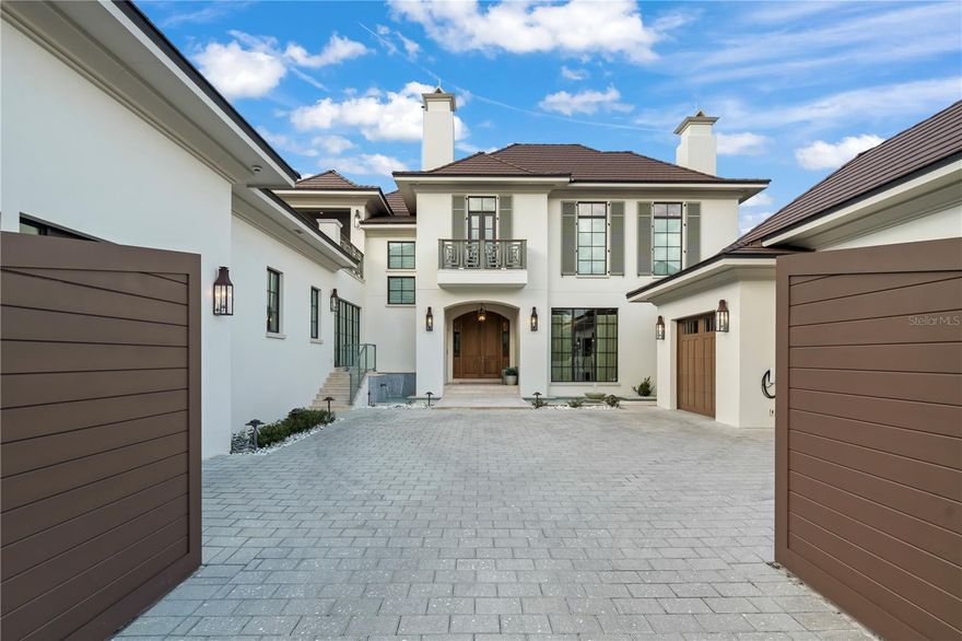 Celebrate Golden Oak’s most impressive and technologically advanced residence, crafted into a masterpiece of elegance, form, and style – tucked away in the most sought-after section of Golden Oak: the coveted Four Seasons Private Residences Orlando at Walt Disney World® Resort.  Be enchanted by a setting unlike any other and an estate built to specifications to meet your every wish. Featuring only the highest quality materials, appliances, and fixtures, this expansive Jones-Clayton home stands supreme with 6-bedroom suites (two downstairs and four upstairs including the primary), secondary Four Seasons kitchen, and a separate attached 2-story maker space that could be an additional bedroom, nanny’s quarters, or attached flex room. Built for ultimate privacy with a circular driveway and the only privately gated residence inside the FS section, creating a walled compound with a 6-foot tall barrier plus hedges along the sides, and an unobstructed view of the nature preserve to the back, for the utmost in exclusivity and seclusion. Flowing fountains and waterfalls welcome visitors at the entrance. Inside you’ll find custom woodwork and wall-to-wall hickory wood floors, soaring ceilings throughout, designer light fixtures, quartz and marble countertops, Busby cabinets and built-ins, CRI & DMF lighting, and a stunning 2-story travertine fireplace. The sprawling primary retreat spans 926 sf across its TV/fireplace lounge, bathroom with a deep soaking bubble-massage tub, spacious closet with island, and spare room with a view. A truly one-of-a kind residential showplace, this home's electrical wiring was designed by an expert Disney professional engineer, and it is fortified with fire-rated drywall, Icynene insulation, a lightning protection system and whole house surge protection. Special attention was paid to the extensive Carrier HVAC system with inline dehumidifiers and UV air cleaners. Located just steps from the Four Seasons amenities and 4 miles from the Magic Kingdom Park, this home sets the standard for the ultimate Golden Oak at Walt Disney World® experience.  This residential resort community is where families can live in the embrace of luxury, privacy, and the magic of Disney. Golden Oak is a gated community featuring distinctive neighborhoods of magnificent homes, expansive natural preserves, and inviting amenities—including Golden Oak’s private clubhouse, Summerhouse, with superb food offerings served in a casually elegant dining room, courtyards, pool area, fitness facilities, and family room. Additionally, as a Four Seasons Private Residences owner, you can enjoy an elevated lifestyle with access to the Four Seasons resort where fantasies are fulfilled daily. This unsurpassed enclave offers unmatched amenities combined with all the benefits and access provided by Golden Oak ownership, including Summerhouse, Golden Oak Member Services, theme park transportation, and additional exclusive resident-only benefits. The premier 18-hole Tranquilo Golf Course at the Four Seasons is located on-site and offers separate membership opportunities. Nowhere else can you live so close to the magic in a setting perfectly suited to create your own happily ever after.