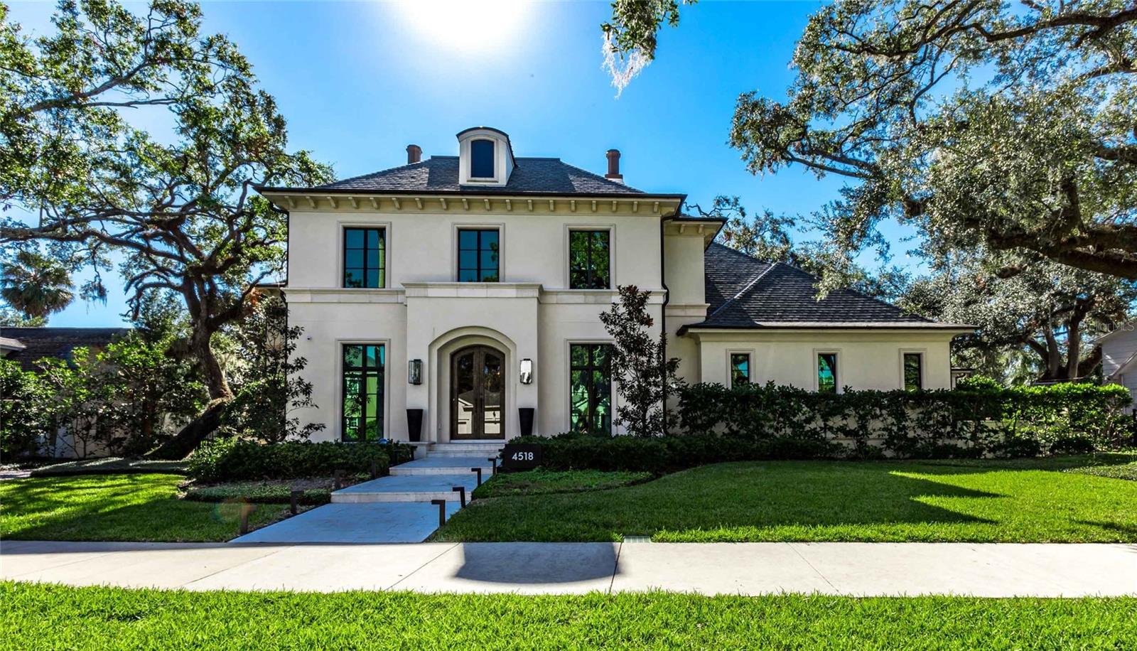 Stunning South Tampa Windstar custom-built single-family home located in the desirable Beach Park neighborhood. Completed in 2018 and thoughtfully updated in 2022. This luxurious residence spans over 6,200 square feet and offers 5 bedrooms, 5 full bathrooms, and 2 half bathrooms. The gourmet kitchen is equipped with SubZero appliances, Wolf gas range, a built-in coffee center, two dishwashers, an ice machine and a spacious walk-in pantry, making it a chef’s dream. The master suite is a private retreat featuring his-and-her bathrooms and closets, a steam shower, and a cozy gas fireplace. Additional amenities include an elevator, a laundry
room outfitted with two washers and dryers, along with ample storage. For car enthusiasts, the property also offers two two-car garages with three lifts, accommodating up to seven vehicles. A versatile bonus room on the third floor, complete with an attached bathroom and closet, can serve as a fifth bedroom, nanny quarters, playroom, or workout room. Outdoor living is a true highlight of this luxury property, featuring a pickleball court, a swimming pool with a slide, a putting green, a gas fire pit, and a spacious yard for recreation and relaxation. The first floor boasts a large playroom/bonus room, office and a family room that opens onto an expansive covered porch with phantom screens and a built-in summer kitchen, making it ideal for entertaining. A full-house generator adds to the home's practicality and security. Situated on an oversized 140 x 144 lot (approximately 0.46 acres), this residence combines elegance, entertainment, and functionality, making it a standout in the sought-after Beach Park neighborhood.