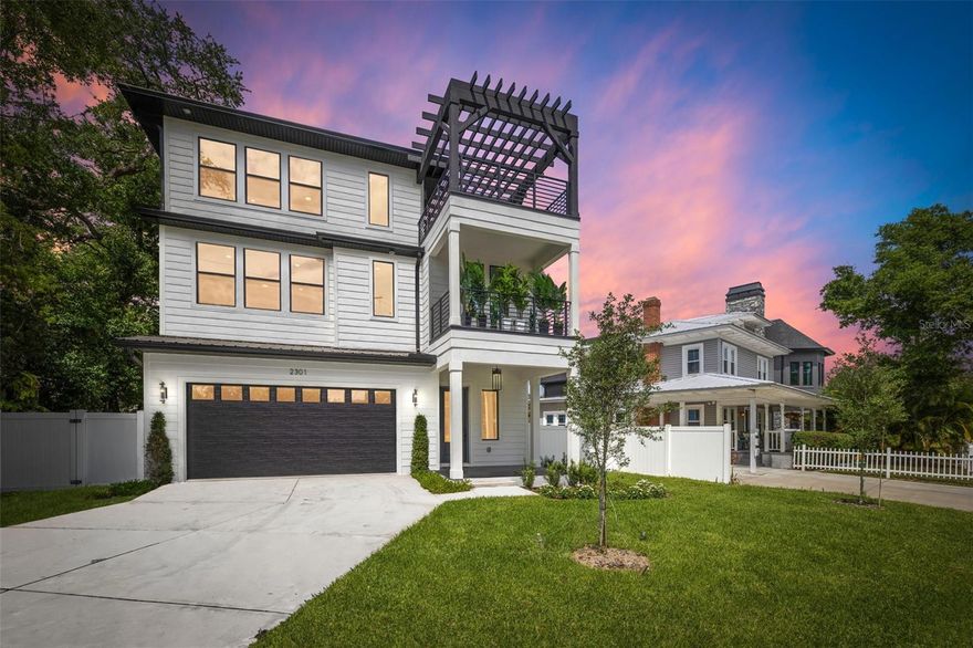 Welcome to this stunning brand-new construction in the highly coveted Ridgewood Park neighborhood of Tampa, where modern luxury meets timeless Key West charm. With 5 bedrooms, 4.5 bathrooms, and thoughtfully designed living spaces throughout, this home offers both style and substance in one exceptional package. From the moment you arrive, the inviting architecture and clean lines set the tone. Inside, engineered oak hardwood flooring flows seamlessly throughout, leading you into a bright and open living space anchored by a sleek electric fireplace and custom accent wall. The chef’s kitchen is a true showpiece, featuring quartz countertops, a custom fluted island, stainless appliances, and a built-in wine fridge. Just steps away, a beautifully designed custom bar area - with an additional wine fridge - creates the perfect setting for entertaining, conveniently located across from the dining space. Upstairs, a spacious loft/game room offers flexible living, ideal for a media room, play space, or additional lounge area. The primary suite is a luxurious retreat, complete with a custom walk-in closet system and a spa-inspired en-suite bathroom featuring a soaking tub and an oversized walk-in shower. Step outside and take in one of the home’s most impressive features - a private rooftop terrace with sweeping views of the downtown Tampa skyline, perfect for sunset gatherings or quiet evenings under the stars. Additional highlights include a 2-car garage, Tesla charger, irrigation system, fenced backyard, oversized laundry/mudroom, and Category 6 wiring throughout. Located in a non-flood zone for added peace of mind. All of this just a short 13-minute walk to some of Tampa’s most desirable destinations, including Armature Works, Ulele, and the Riverwalk - bringing dining, entertainment, and waterfront living right to your doorstep. This isn't just a home, it's where your story begins