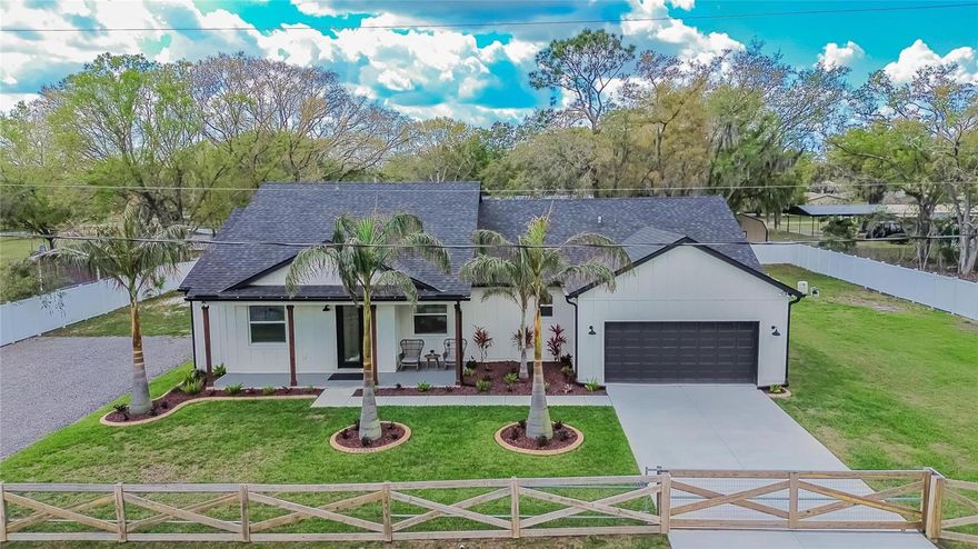 Welcome to your private half-acre retreat in Plant City! Built just 2 years ago, this move-in ready home offers modern living with space, privacy, and endless possibilities. Step inside to a bright open-concept layout perfect for entertaining, with a large oversized pantry that can easily function as a butler’s pantry, coffee station, prep kitchen, or incredible storage space. The property has been thoughtfully upgraded with front fencing for added privacy, gutters, whole-home water filtration, window blinds, and a camera security system. Outside you’ll love the gorgeous landscaping with irrigation and the convenience of two driveways, including a new crushed asphalt driveway with plenty of room for guests and extra vehicles. Bring your RV, boat, trailers, and all the toys—this property has the space! With a half-acre lot, there’s also potential for a detached garage, workshop, or future ADU. Relax on the porch and enjoy peaceful surroundings, where you’ll hear birds chirping and chickens singing in this quiet neighborhood filled with nature. If you’re looking for a newer home with space to create your own oasis, this is it.