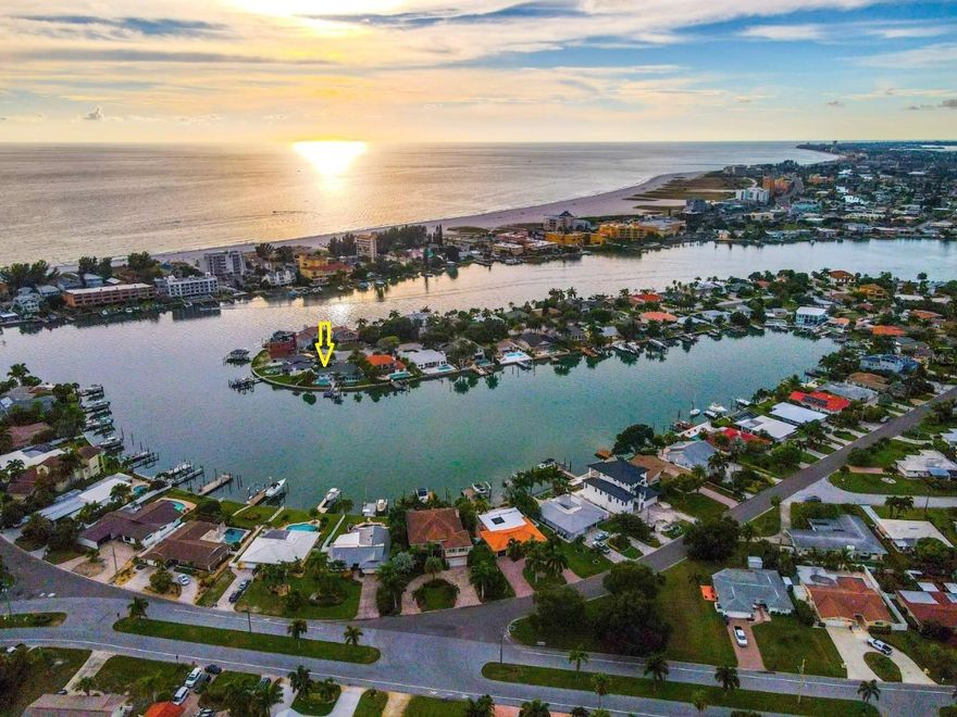 Paradise Island in Treasure Island. Three bedroom, two bathroom home located on a cul-de-sac with 129.5' of seawall on the intercoastal waterway and Blind Pass Channel with deep water and just minutes to the Gulf of America. Backyard is an oasis with an in ground pool with fountains and a new pool pump, artificial turf in both the front and back with a large putting green. New fence and landscaping. Water views from almost every room. Wood burning sandstone fireplace. Kitchen features a built-in breakfast bar, new kitchen cabinets, countertop and backsplash, touch faucet and Samsung smart appliances and pantry. Master bathroom recently remodeled with marble walls and floors and glass shower door, new bathroom vanities in both bathrooms. The entire house has new 6" baseboards, new interior doors, new closet doors, new luxury vinyl tile in the bedrooms, new drywall, texturing and paint. New hot water heater, new electrical outlets, new circuit breakers, AC 2021, roof 2009. Hurricane windows and sliding doors. Two car garage with new garage door, overhead storage, storage room and an additional room with portable AC which could be used for an office or exercise area. The composite dock has a 10,000 pound boat lift, water, electric, bench seating and fishing station. Seawall replaced in 2008 and fortified with extra rip rap. Recently painted exterior and updated lighting. Outstanding location; only minutes to downtown Treasure Island and the beach and to the Gulf of America by foot or by boat.