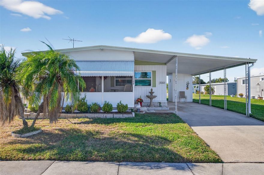 WELCOME TO YOUR AMAZING HOME at 3243 Hampshire Dr, Holiday in the SUPERB community of Tanglewood Mobile Village Condominium, a 55+ community in SUNNY Florida. This SPACIOUS 2 bedrooms + screened & covered lanai, 2 bathrooms double-wide mobile home lies on a larger lot with nearly 4500 sqft in a NO CDD or NO FLOOD zone & LOW HOA. Key exterior features are covered carport parking, storage shed/workshop area with built-in shelving, screened porch, open patio in the back yard, rain gutters, shutters over the windows for storm protection, private mailbox & easy-breezy TROPICAL landscaping that is taken care of for you. House systems have been updated too: sturdy METAL roof, updated electrical panel & AC. When you step inside, you'll LOVE the OPEN FLOOR PLAN consisting of the foyer, kitchen, living & dining rooms & HUGE lanai. The lanai has high VAULTED ceilings, lighted wall sconce & double glass sliding doors into the living room. The WONDERFUL living room has a beadboard ceiling & faux brick feature wall to provide detail & warmth to the room. The updated kitchen features a double sink, wood cabinets with beadboard doors & handles, matching beadboard ceiling, expansive laminate counters & newer appliances including a fridge, smooth-top range & microwave. The pantry closet doubles as the laundry with the full-size washer & dryer machines included in the sale. Create memories during mealtime in the CHEERY dining room with matching cabinets/buffet & beautiful chandelier. NATURAL SUNSHINE streams inside through the multiple DOUBLE-PANE, LOW E, THERMAL TINTED WINDOWS WITH CUSTOM BLINDS illuminating the interior together with the BRIGHT light fixtures. The primary bedroom can fit king-size furniture & has a private bathroom. The primary bathroom features a step-in shower with ceramic tiled wall, perfectly fitting cabinet with sink, linen closet, newer toilet with bidet & pocket door for privacy. The second bedroom is comfortable with a queen bed & closet. The guest bathroom consists of expansive laminate counter, cabinet storage, tiled tub/shower combo, newer toilet with bidet & linen closet in the hall. This TURN-KEY HOME is TRULY MOVE-IN READY & SOLD FURNISHED (if desired). Tanglewood Mobile Village is a SUPERB 55+ COMMUNITY & included in the low HOA fee of $143/month is trash with recycling pick-up 2X week, all exterior lawn maintenance, street lights & recreational activities like HEATED POOL, shuffleboard & clubhouse where many social activities take place. Location is IDEAL near beaches, shopping, restaurants, medical plazas, places of worship & tourist attractions. MAKE THIS YOUR FUTURE HOME!