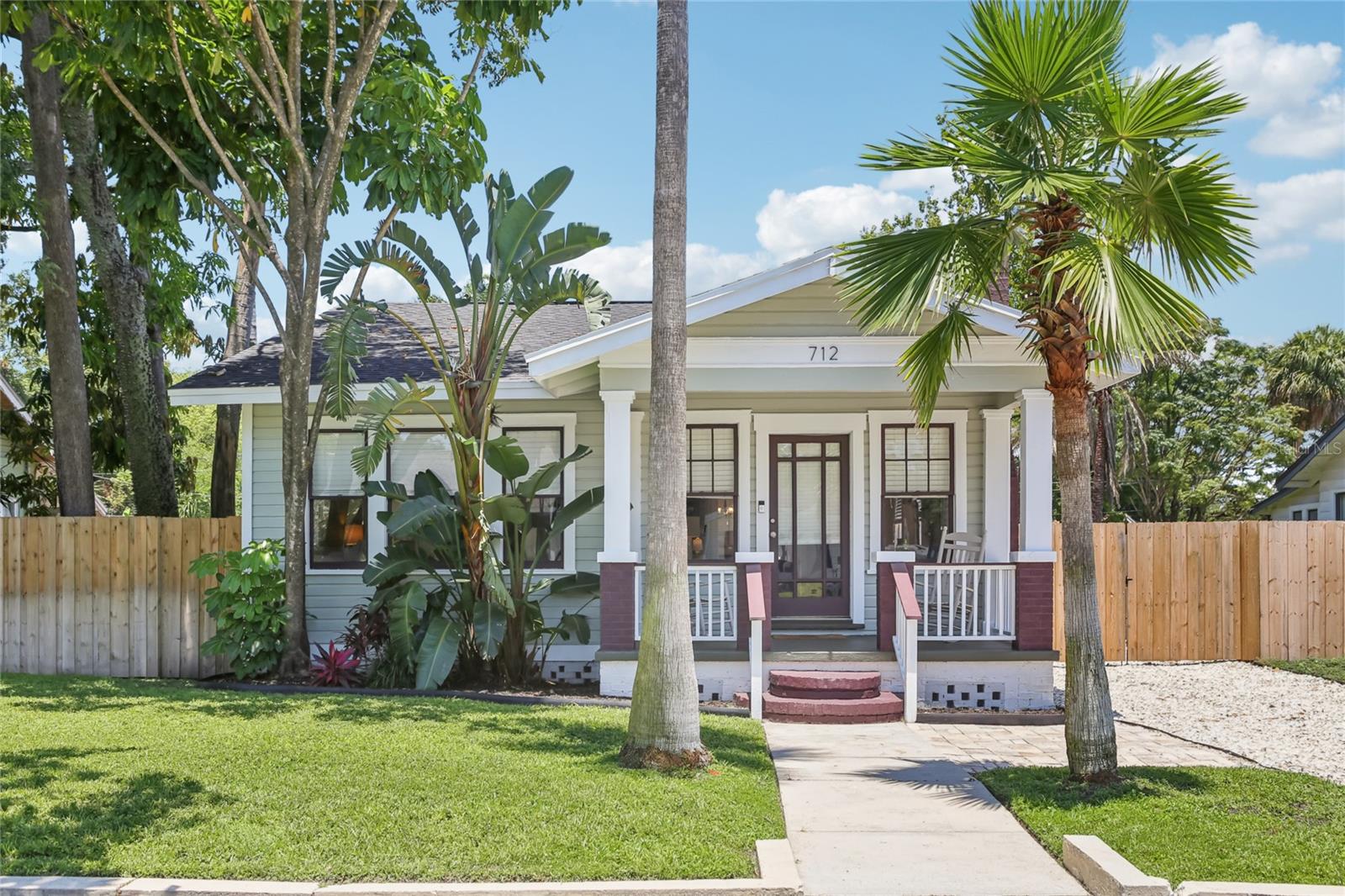 **Timeless Charm Meets Modern Comfort in the Heart of Seminole Heights!** Step into this beautifully updated 1925 wood-frame bungalow offering the perfect blend of vintage character and contemporary living. With 2 spacious bedrooms and 2 full baths—including a private en-suite and walk-in closet in the primary suite—this home is designed for comfort and functionality. You'll love relaxing on the inviting front porch or entertaining in the wide, open living area that flows seamlessly into a generous dining room and a large, well-equipped kitchen. Situated on a deep 60x133 ft lot, the fully fenced backyard is a private retreat, featuring a manicured lawn, expansive deck, and plenty of space to unwind or entertain. With gate access from both the front and rear (E Wilder Ave), you'll enjoy unmatched flexibility for parking multiple vehicles, your RV, or even a boat. Recent updates include fresh interior/exterior paint, a newer roof, and HVAC—ensuring peace of mind for years to come. Located just minutes from I-275, downtown Tampa, Water Street, Armature Works, and all the eclectic restaurants and bars that make Seminole Heights one of Tampa’s most desirable neighborhoods.