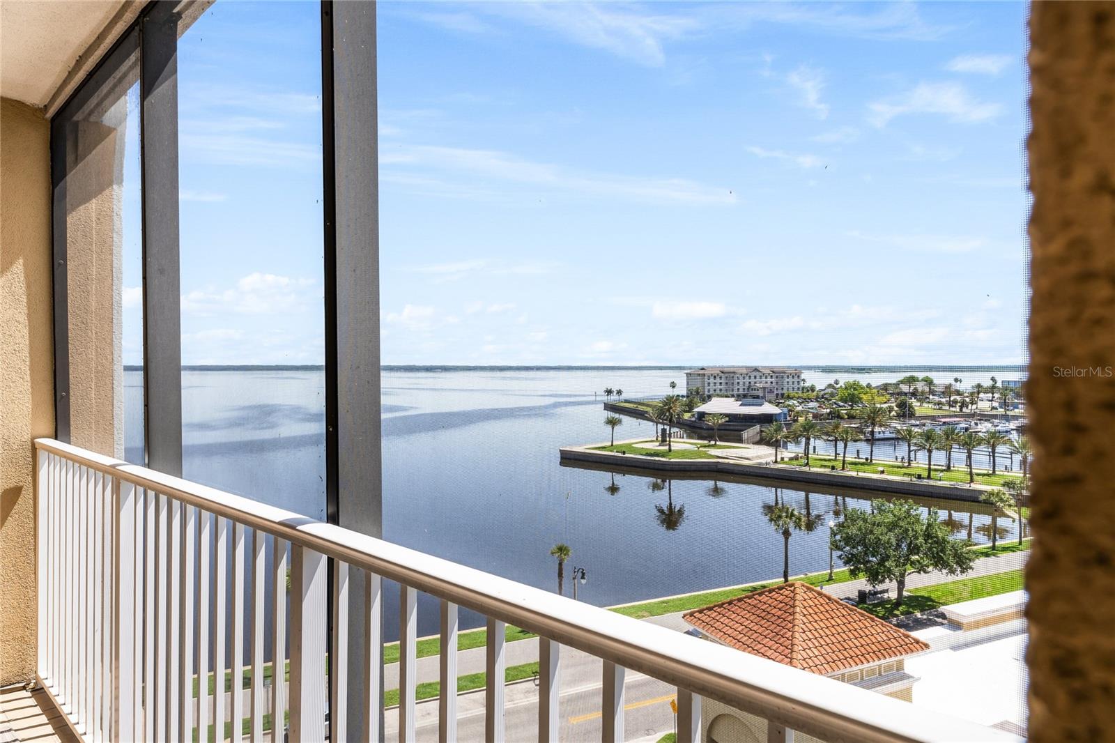 Experience luxury living in this stunning penthouse condo located in highly sought-after Gateway at Riverview in historic downtown Sanford, Florida * Perched on the top floor of a six-story building, this exquisite 4-bedroom, 4-bath (3 ensuite), almost 3,300 square foot home lives large with unparalleled panoramic views of Lake Monroe, a sprawling 9,046-acre lake that's part of the renowned St. Johns River system, as well as breathtaking cityscapes * Enter the home from a spacious screened front porch through double front doors leading to the foyer with line-of-sight view of the lake & harbor * The interior is a showcase of elegance and modern convenience, featuring soaring 10' to 11' ceilings, crown molding and hardwood floors * The living space is further enhanced by a custom built floor-to-ceiling entertainment console, with wet bar, wine chiller, and book & display shelving with lighting * The gourmet chef style kitchen shines with amenities including a cabinet paneled classic French Door Sub-Zero refrigerator, center island workspace, 48" cherry cabinets, granite countertops, and a walk-in pantry * Layout includes an eat-in area in the kitchen and ample space for formal dining in the great room, providing versatile dining options for intimate meals or larger gatherings * Dual primary bedroom retreats with en-suite baths, dual sinks, and walk-in closets, offer spectacular views overlooking the lake and marina * The other bedrooms are both large and well-appointed with their own walk in closets * Storage & functionality are throughout, starting in the foyer with dual double door closets with additional storage in the large laundry room off the kitchen * 3rd bedroom has built-in features and currently serves as an office * Step outside to enjoy the serene surroundings, whether on the private screened 25’ long balcony overlooking the water and marina or from the inviting screened front porch entryway. The open-concept layout seamlessly blends elegance & comfort, making it ideal for both everyday living and hosting gatherings. As a resident of Gateway at Riverview, you'll enjoy an array of premium amenities covered by the association fee, including Spectrum High-Speed Internet and Cable with a premium package, water, trash, and sewer services, even maintenance of the rooftop A/C unit when needed. The grounds are well maintained with lawn care and janitorial services, while additional perks include access to a small gym, stylish clubhouse & comprehensive pest control. Safety & convenience are paramount, with the building featuring a secured key fob entry system that uses advanced video intercom technology or QR code access. 2 covered parking spaces (one in the secured garage and another under the awning) * In front of the Gateway at Riverwalk, on the southern shore of Lake Monroe is easy access to a 5-mile-long multi-use trail for your enjoyment! * HOA dues are approximately $1,423/month (includes both parking spaces) * Don’t miss this rare opportunity to make this exceptional property your own * Founded in 1877, Sanford is charming with a vibrant downtown including restaurants, cafes, bars, art studios, coffee shops, independent businesses, and festivals like the annual Sanford Porchfest * Located in the heart of Central Florida with easy access to the theme parks, beaches and Space Coast, this penthouse is not just a home, it's a lifestyle, offering a unique blend of modern comfort & historic charm in the heart of downtown Sanford!