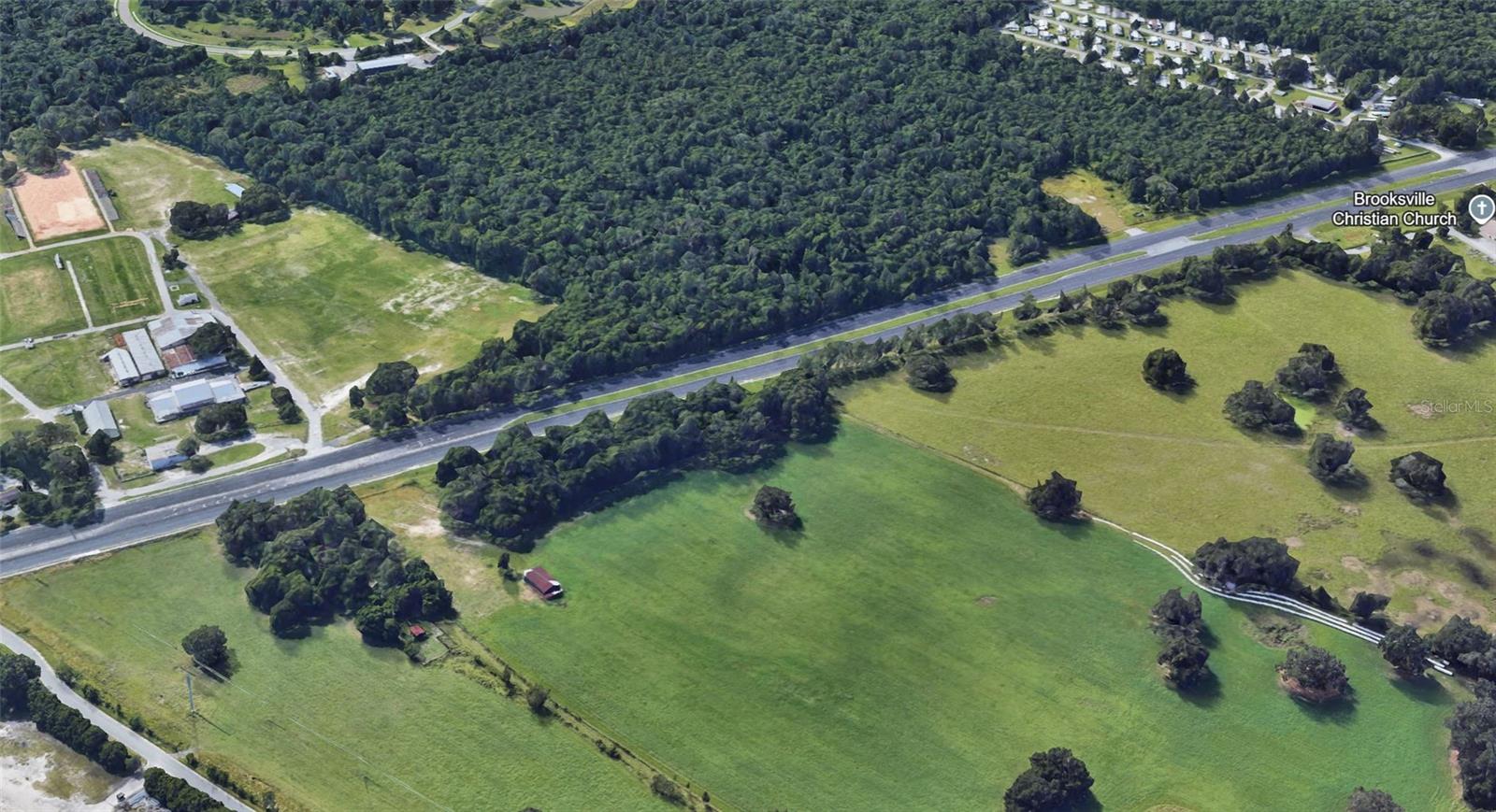 Just shy of 1 acre with approximately 292 feet of highway frontage along U.S. Highway 41 in Brooksville, FL. This high and dry parcel is not in a flood hazard area and offers excellent visibility—making it an ideal site for your next commercial development. Whether for retail, office, or service-based business, this location offers strong long-term growth potential.
Zoning: C-3 Neighborhood Commercial
C-3 zoning supports a wide variety of neighborhood-serving uses, including:
• Convenience goods stores (max 2 checkout lanes, 2 fueling stations)
• Personal service establishments (salons, dry cleaners, etc.)
• Professional, business, and nonprofit offices
• Public offices and utility facilities
• Package liquor sales and restaurant beverage service
• Delicatessens and restaurants with 40 or fewer seats
• One single-family dwelling unit (600+ sq. ft.) integrated into the business structure
• Day care centers and nursing care homes
This flexible zoning is suitable for owner-occupants and investors alike.
Traffic & Visibility
Located just south of the Hernando County Fairgrounds, the property benefits from an Average Annual Daily Traffic (AADT) count of approximately 27,000 vehicles per day, per FDOT. Broad Street (U.S. 41) is a major arterial with strong local and regional flow.
Nearby Businesses & Activity Hubs
Situated along Brooksville’s primary commercial corridor, the parcel is surrounded by national retailers and local amenities, including:
• Lowe’s Home Improvement
• Walmart Supercenter
• Nick Nicholas Ford
• Capital City Bank
• Publix, CVS, Walgreens, Advance Auto Parts, and Tractor Supply
• Several local restaurants, banks, and professional offices
• Minutes to Downtown Brooksville, the courthouse, and Hernando County government offices
Residential & Demographic Demand
• Close to Southern Hills Plantation (gated golf community)
• Near Brookridge, Sherman Hills, and Trillium—all high-density residential areas
• Strong demand for commercial services in the surrounding residential zones
Strategic Regional Access
• 0.5 miles to SR-50 (Cortez Blvd)
• 2 miles to U.S. Highway 98
• 5 miles to the Suncoast Parkway (SR-589)
• 8 miles to Interstate 75 (via SR-50 E)
Central Florida Location
• 45 miles to Tampa (~50 minutes)
• 60 miles to St. Petersburg (~1 hr 10 min)
• 58 miles to Clearwater (~1 hr)
• 85 miles to Orlando (~1 hr 30 min)
• 10 minutes to Brooksville–Tampa Bay Regional Airport (BKV)
• 55 minutes to Tampa International Airport
This commercial parcel combines excellent visibility, flexible zoning, strong demographics, and strategic location—making it a standout opportunity for investors and end users alike.