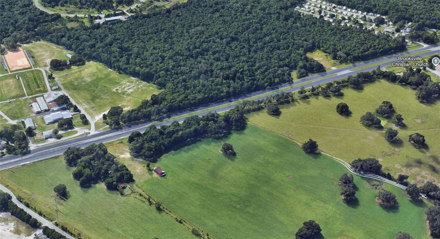 Just shy of 1 acre with approximately 292 feet of highway frontage along U.S. Highway 41 in Brooksville, FL. This high and dry parcel is not in a flood hazard area and offers excellent visibility—making it an ideal site for your next commercial development. Whether for retail, office, or service-based business, this location offers strong long-term growth potential.
Zoning: C-3 Neighborhood Commercial
C-3 zoning supports a wide variety of neighborhood-serving uses, including:
• Convenience goods stores (max 2 checkout lanes, 2 fueling stations)
• Personal service establishments (salons, dry cleaners, etc.)
• Professional, business, and nonprofit offices
• Public offices and utility facilities
• Package liquor sales and restaurant beverage service
• Delicatessens and restaurants with 40 or fewer seats
• One single-family dwelling unit (600+ sq. ft.) integrated into the business structure
• Day care centers and nursing care homes
This flexible zoning is suitable for owner-occupants and investors alike.
Traffic & Visibility
Located just south of the Hernando County Fairgrounds, the property benefits from an Average Annual Daily Traffic (AADT) count of approximately 27,000 vehicles per day, per FDOT. Broad Street (U.S. 41) is a major arterial with strong local and regional flow.
Nearby Businesses & Activity Hubs
Situated along Brooksville’s primary commercial corridor, the parcel is surrounded by national retailers and local amenities, including:
• Lowe’s Home Improvement
• Walmart Supercenter
• Nick Nicholas Ford
• Capital City Bank
• Publix, CVS, Walgreens, Advance Auto Parts, and Tractor Supply
• Several local restaurants, banks, and professional offices
• Minutes to Downtown Brooksville, the courthouse, and Hernando County government offices
Residential & Demographic Demand
• Close to Southern Hills Plantation (gated golf community)
• Near Brookridge, Sherman Hills, and Trillium—all high-density residential areas
• Strong demand for commercial services in the surrounding residential zones
Strategic Regional Access
• 0.5 miles to SR-50 (Cortez Blvd)
• 2 miles to U.S. Highway 98
• 5 miles to the Suncoast Parkway (SR-589)
• 8 miles to Interstate 75 (via SR-50 E)
Central Florida Location
• 45 miles to Tampa (~50 minutes)
• 60 miles to St. Petersburg (~1 hr 10 min)
• 58 miles to Clearwater (~1 hr)
• 85 miles to Orlando (~1 hr 30 min)
• 10 minutes to Brooksville–Tampa Bay Regional Airport (BKV)
• 55 minutes to Tampa International Airport
This commercial parcel combines excellent visibility, flexible zoning, strong demographics, and strategic location—making it a standout opportunity for investors and end users alike.