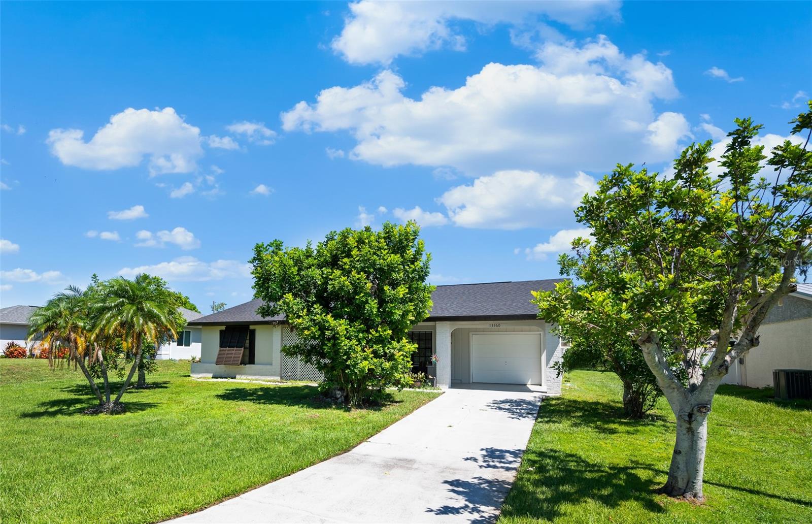 This stylish home in Gulf Cove is the perfect blend of comfort, convenience and charm – whether you are looking for a seasonal retreat or a year-round residence under the Florida sun! With a NEW ROOF (2022) and NEW A/C (2021) already in place, you’ll enjoy peace of mind. ~~~Start your mornings on the expansive front porch, coffee in hand, greeting neighbors and soaking in the charm of this friendly community. Step inside and find a bright, OPEN FLOORPLAN with modern tile flooring and abundant natural light. The spacious living room invites you to relax or entertain, while the chef-inspired kitchen takes center stage with GRANITE COUNTERS, subway tile backsplash, stainless steel appliances, and an island for prep and gathering. A BUILT-IN BAR with pass-through to the Florida room makes hosting effortless, whether for casual drinks or weekend brunch. ***The dining room is a showstopper, featuring a cathedral wood ceiling with skylight that creates a warm, inviting atmosphere for both intimate dinners and holiday celebrations. Need more space? The MASSIVE FLORIDA ROOM is a blank canvas, ideal for a hobby space, a game of cards or dining in the breeze. ~~~At the end of the day, retreat to your primary suite with engineered hardwood flooring and an EN-SUITE BATH with a beautifully tiled shower. Guests will appreciate their own bedroom and full bathroom for accommodations. A convenient laundry room with half bath leads to the AIR-CONDITIONED GARAGE. A large backyard is perfect for a game of cornhole or lounging in the sun. ***Located in Gulf Cove, residents have the option to join the association for access to a RIVERFRONT PARK WITH PLAYGROUND AND BOAT RAMP on the scenic Myakka River. Be just minutes from 776 and a variety of dining and shopping. Enjoy all the are attractions, including world-class boating and fishing, the sandy beaches of Boca Grande, multiple golf-courses and two Major League Baseball Spring Training stadiums. ~~~Don’t just dream of Florida living – make it yours today! Schedule a showing and experience all this Gulf Cove gem has to offer.