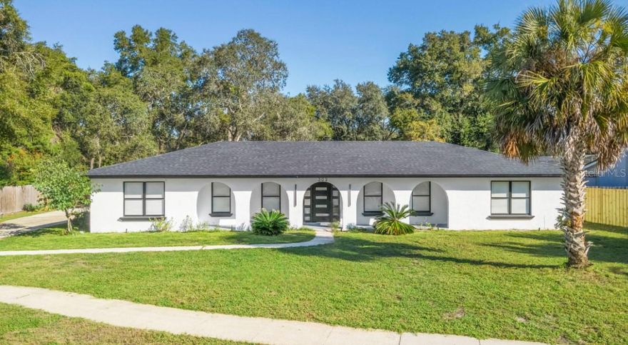 One or more photo(s) has been virtually staged. Welcome to this beautifully updated four-bedroom, two-bathroom pool home on a spacious 0.34-acre lot in one of Longwood’s most desirable neighborhoods. This charming Mediterranean-inspired ranch blends timeless character with modern upgrades and smart-home convenience. A covered front porch with graceful arches and a freshly painted concrete floor sets the tone for this warm and inviting home. Inside, the open-concept floor plan is highlighted by abundant natural light, recessed lighting, and brand-new luxury vinyl plank flooring throughout, with tile in the bathrooms. The living area also features a cozy wood-burning fireplace and flows seamlessly into the stunning fully renovated kitchen.
The kitchen is the heart of the home, showcasing a striking waterfall cooking island, ample cabinetry, and sleek countertops. A modern ceiling-mounted recessed range hood with smart remote control and a stackable smart oven and microwave combo with touch-screen settings add both convenience and sophistication. Every sink and faucet in the home is upgraded to smart digital faucets with temperature-sensitive controls.
The primary suite offers a spacious walk-in closet and a beautifully renovated en-suite bathroom with sliding glass shower doors. The guest bath includes a skylight for natural light, poured countertops, and direct access to the pool area — perfect for entertaining.
Outdoor living is just as impressive, with a screened-in back porch overlooking the pool, a laundry room with pool access and utility sink, and a side-entry garage with extended driveway providing plenty of parking. Additional features include mirrored sliding closet doors in every bedroom, as well a NEW 2025 HVAC & roof. 
This home’s location is truly unbeatable. Just minutes from Lake Brantley and around the corner from Wekiwa Springs State Park, residents can enjoy miles of trails, canoeing, kayaking, and endless outdoor adventures. Zoned for top-rated schools including Sabal Point Elementary, Rock Lake Middle, and Lyman High School, this property offers the perfect blend of style, comfort, and convenience in the heart of Longwood.