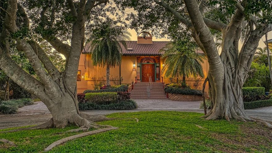 Lose yourself in coveted Country Club Shores on Longboat Key in this 3-4-bedroom, 4.5-bath richly appointed home on a widely protected canal. Over 150’ of newly recapped seawall with lifts. The water can accommodate up to a 60’ boat. So many wonderful memories have been made here! The foyer is impressive with its rustic shell-stone flooring and carved wood entry doors. It is flanked on either side by two en-suite guest bedrooms, each with plenty of privacy. The home has splendid cathedral ceilings. The spacious living room has rich, travertine flooring and a grand fireplace. Newer, hurricane-rated sliding doors can open directly onto the gas heated, screened, 16’x35’ pool. The large dining room is open to the living room with ample space for a stately dining table. Built-ins there provide a perfect buffet. The office/den/4th bedroom is tucked away with a lovely corner window. The spacious owner’s retreat opens to the screened lanai and heated pool where you can enjoy the dolphin statue and the glistening water. Its bath offers dual sinks, a free-standing Roman tub, a large shower and plenty of natural light. The kitchen features beautiful wood flooring, a large center island with gas cooktop, wall ovens, warming drawer, worlds of cabinet space, a wine cooler, beverage refrigerators, a wonderful porcelain farm sink, and plenty of work/serve space. The kitchen is open to a huge family room with a fireplace, floor-to-ceiling windows that invite the outdoors in, and sweeping views of the wide, long canal. There are myriad ways to entertain others and yourself here. Host large parties in the grand dining room, or smaller ones in the vast, open kitchen/family room. The pool is yet another place to share your home. The home wraps around and can be fully opened for a seamless flow of guests. The lot is over a third of an acre with an extensive, brick paver drive. There is easy parking for 4 cars in the spacious garage area. See the features sheet for additional details. Country Club Shores is one of the most sought-after waterfront communities in a very convenient location on the south end of Longboat Key. Put your toes in the sand and hear the waves lapping in the Gulf of Mexico in just a few minutes through an easement for Country Club Shores located at the end of the Longboat Key Club, Gulf front golf course near the crossing light. The world-renowned Longboat Key Club is close by, where members enjoy first-class amenities and 5-star service. You’ll be just a short drive away from the upscale shops of St Armand's Circle and downtown Sarasota. The location can’t be beat. This home tells a story. Make the next chapter yours!