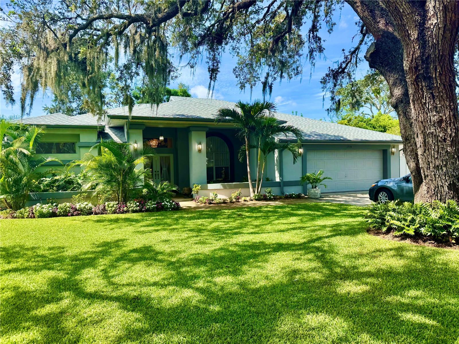 This impressive 3 bedroom, 2 bathroom home with soaring vaulted ceilings is situated on an enormous, beautifully landscaped lot, truly resembling a park-like garden, with established trees, tropical foliage and stunning floral displays throughout the property. In addition to the three spacious bedrooms, this home includes a versatile bonus room that makes for an ideal home office, studio, or playroom, offering flexibility to suit your lifestyle. As you step inside, you're immediately greeted by an enormous sense of space created by the vaulted ceilings that provide a grand and airy atmosphere. These high ceilings not only open up the living space but also allow for an impressive amount of natural light to pour in, giving the entire home a bright and inviting feel.
Take comfort in the brand-new roof, offering peace of mind for years to come. The HVAC system is also newer (installed in 2021), ensuring energy-efficient comfort throughout the seasons.
The kitchen and living areas flow seamlessly together, making this home perfect for entertaining or spending quality time with family. The generously sized primary bathroom offers a spa-like retreat, featuring a large sit-in whirlpool tub that invites you to unwind and relax after a long day.
But the true showstopper of this property lies outdoors. Sitting on an expansive lot of over 13,000 square feet, the yard is nothing short of a tropical oasis. Surrounded by lush, mature landscaping, the backyard feels like a private getaway—ideal for family gatherings, gardening, or simply enjoying the Florida sunshine. There is obviously plenty of room for a pool – or two! A beautiful design and decades of care have made this a true garden masterpiece. Moreover, the entire yard is irrigated using a well water system, allowing you to maintain the beautiful landscape without impacting your monthly water bill. A large shed in the backyard provides ample storage for tools, lawn equipment, or outdoor gear.
The screened-in back patio, complete with a built-in sink, is perfect for entertaining guests or enjoying quiet mornings with a cup of coffee while soaking in the view of your serene backyard. Whether you're hosting a summer barbecue or enjoying a peaceful evening outdoors, this space offers the best of Florida indoor-outdoor living.
The oversized two-car garage provides plenty of room for vehicles, storage, or a workshop, while the massive driveway offers abundant parking for guests, boats, or recreational vehicles. There is also an internal laundry room.
This Clearwater gem truly has it all—modern updates, spacious living, and a yard that feels like a private resort. Don’t miss your opportunity to make this exceptional property your next home.