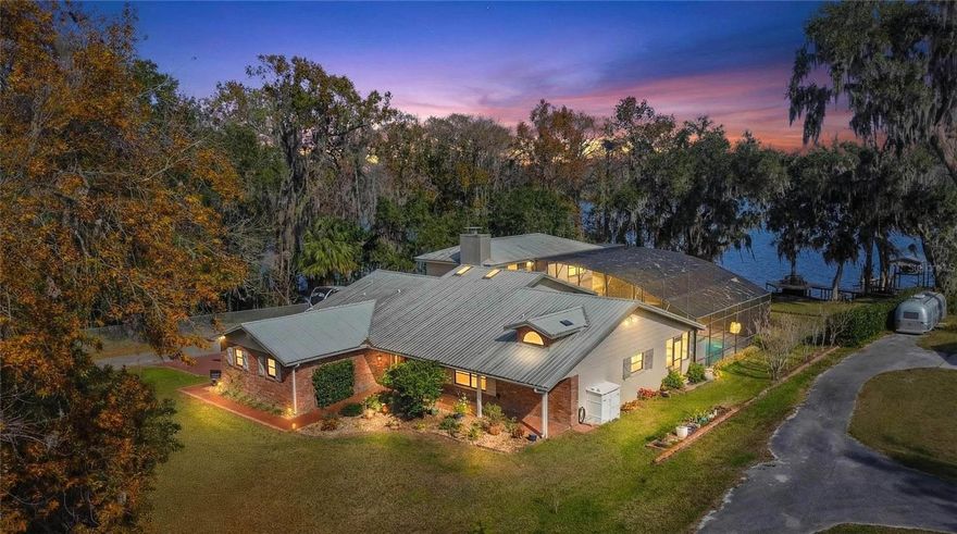 SELLER MOTIVATED....This beautiful and peaceful home is nestled on a perfect lot with Lake Church as its backdrop.  Gorgeous all day views that will make you stand and just enjoy watching nature do its thing.  This 3 bedroom 4 bath home offers 2 Primary Suites one upstairs and the other on the main level and a third bedroom on the main level for whoever needs it as well as your own private SAUNA / STEAMROOM. The kitchen is nicely equipped with a formal Dining room as well as a dinette. SELLER IS MOTIVATED.....
There are amazing Lake views from multiple places in the home plus a large back deck, completely screened in with a perfect sized salt water pool to enjoy all the hot summer days and nights to go along with that ever amazing lake view.  Entertaining in this home will be easy with lots of open areas to have crowds gather comfortably. There is a dock with a sitting area and lift for your boat of which you should enjoy using it on the large relaxing lake. There is also a place to park and RV with a plug power source.
SELLER IS MOTIVATED!