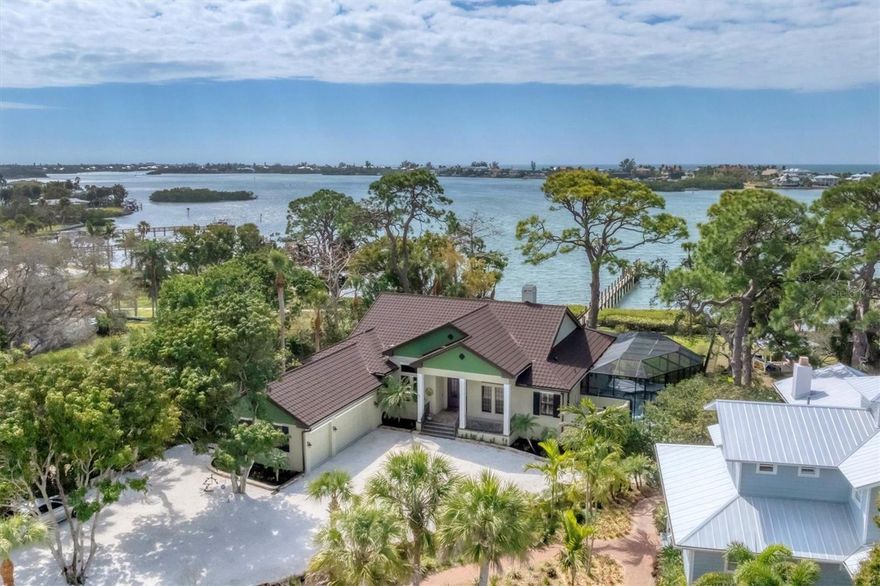 Perched on a lush, half-acre waterfront oasis, this stunning single-family residence blends luxury, sustainability, and coastal charm in perfect harmony. Built in 2012 and completely upgraded just 16 months ago, this nearly 3,000-square-foot home offers an extraordinary lifestyle designed for comfort, elegance, and effortless entertaining. Boasting four bedrooms, three baths, an office, and a spacious three-car garage, this meticulously remodeled property exudes sophistication at every turn. Step through the front door and onto warm luxury vinyl floors, where 11-foot ceilings and freshly painted interiors create an airy, refined ambiance. The heart of this home is a chef’s dream kitchen, reimagined with top-of-the-line features and finishes. Showcasing new electrical and plumbing systems, it’s equipped with high-end, commercial-grade appliances, including a striking BlueStar 10-burner pigeon blue stove with dual convection ovens and a BlueStar French-door refrigerator/freezer with stainless interiors and brass accents. Two U-line stainless refrigerator drawers, a Brizo luxe gold pot filler, and a Kraus Bellucci granite composite sink in metallic gray elevate the kitchen’s functionality and aesthetic. Complemented by 3cm Blue Bahia chiseled-edge granite countertops, a built-in microwave, an ice maker, and a wine cooler, this space is a true masterpiece for culinary enthusiasts and entertainers alike. Attention to detail continues throughout the home. Closets by Design in the primary suite include two spacious walk-ins, ensuring impeccable organization. A whole-house generator and tankless water heater provide reliability, while Aroma 360 systems infuse the air with sophistication via each A/C handler. The new metal roof, designed to resemble classic tile, combines style with durability. Outdoors, the property unveils breathtaking views of Blackburn Bay and 100 feet of private shoreline. A brand-new lighted dock with a 16,000-pound lift, pre-wired for Jet Ski lifts, promises easy access to the water, while a double-rope barrier ensures safety. The fenced backyard is a serene retreat featuring a heated saltwater pool and spa surrounded by lush landscaping and enchanting lighting. The expansive lanai offers a front-row seat to panoramic bay views and unforgettable sunsets, perfect for hosting or unwinding in complete privacy. With two A/C zones for personalized comfort, full-property irrigation — including flower boxes — and a private road shared with only two neighbors, this home is more than just a residence; it’s a lifestyle of exclusive waterfront living. Nestled in the heart of Nokomis, Florida, this property delivers a rare combination of refined luxury, environmental consciousness, and serene coastal beauty. Every element, from the newly remodeled interiors to the sweeping outdoor spaces, reflects thoughtful craftsmanship and timeless elegance. Welcome to your personal piece of paradise, where modern sophistication meets tranquil waterfront living. NO Storm damage at all... Property was High & Dry... Elevation is 13.8ft