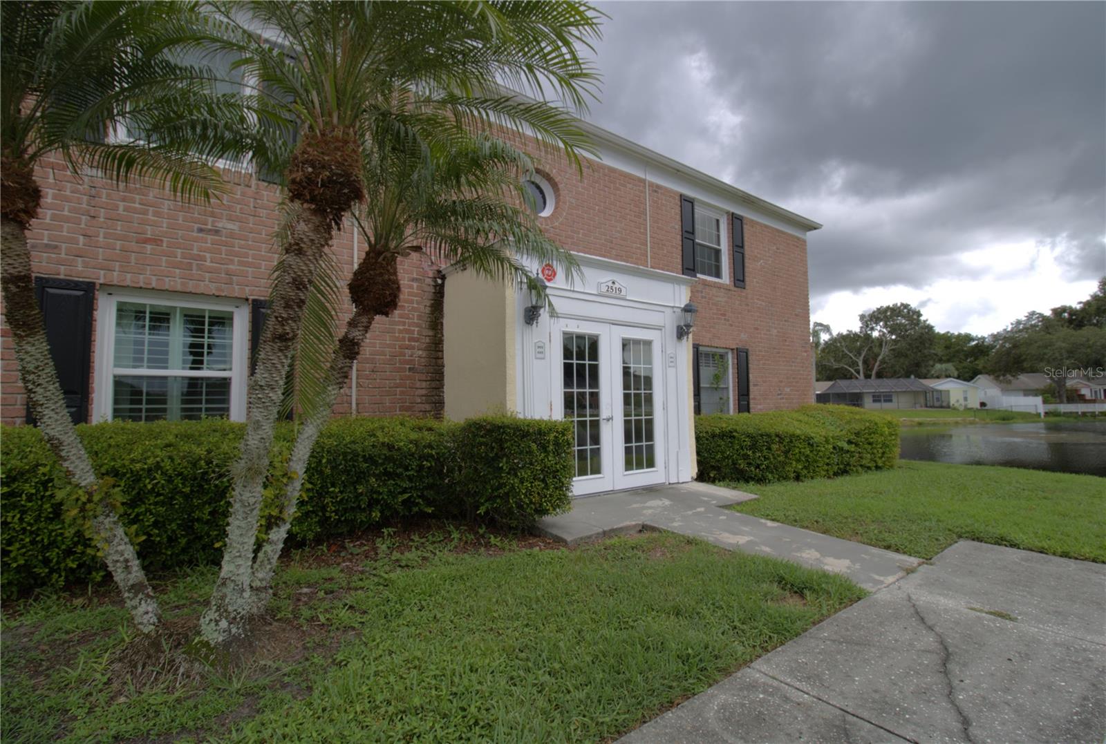Welcome to this well maintained first floor condo in the tranquil, gated community of Whispering Oaks, nestled beside the beautiful Lake Magdalene. This one bedroom, one bath unit features hurricane impact windows, brand new interior paint, a resurfaced bathtub, beautiful hardwood floors, new ceiling fan, and a brand new washer and dryer for added convenience. Step outside to your private, fenced patio, perfect for relaxing or entertaining. Furnishings are negotiable, making this home move in ready. Whether you enjoy jet skiing, canoeing, kayaking, fishing or simply relaxing by the pool, this location offers it all. The community also features boat parking, a 24/7 gym with secure access, laundry room, pool, clubhouse, car wash station, and a community boat ramp. Enjoy your mornings with a breathtaking sunrise on your paved patio overlooking a peaceful pond, sprawling with wildlife. Located off N. Dale Mabry Hwy and W. Fletcher in the heart of Carrollwood, you are conveniently located near shopping, dining, grocery stores, and major highways including I-275, I-75, and I-4. Just 20 minutes from USF, downtown Tampa, Tampa International Airport, and Moffitt Cancer Center. A Capital Contribution to the HOA is due at closing.