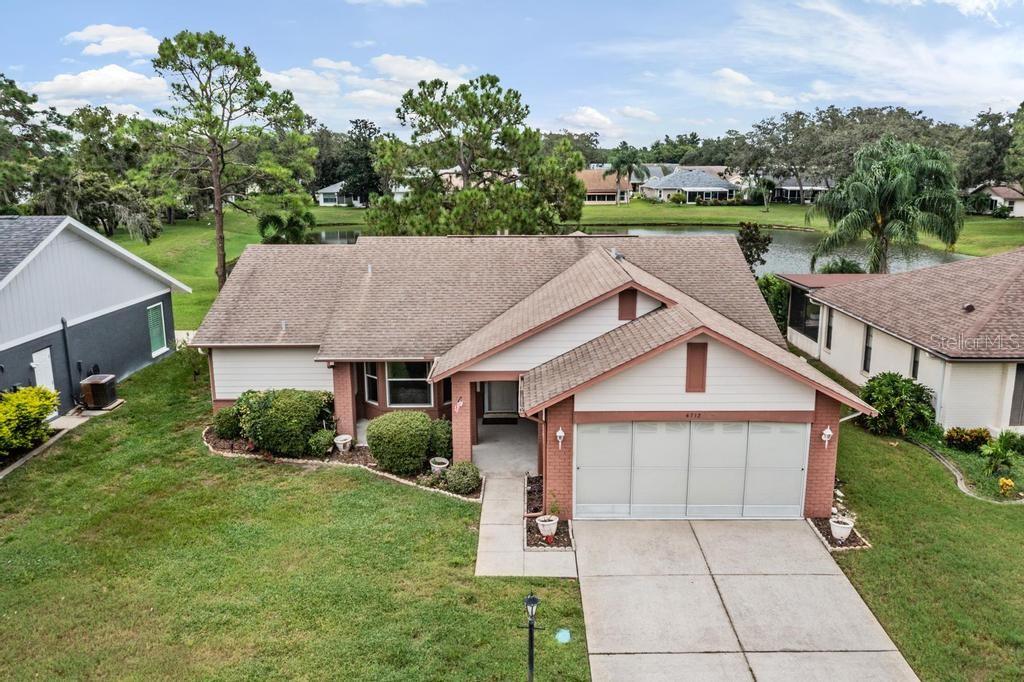 Here is one you've been waiting for! 2BR, 2BA, 2 Car garage home in neighborly 55+ Heritage Lake Community with pond views! Home provides 1776 sq/ft of living space, is well maintained and move in ready. New roof included in price to be installed prior to closing. A/C is approximately 2 years old. Entire inside is freshly painted. Home has been upgraded with double pane, insulated windows and it waiting your own personal touches. Upon entry, notice the spacious living room/dining room combination with wood flooring giving separation from the informal areas of the home. Kitchen displays tile floors and offers plenty of cabinetry with newer, stainless steel appliances. Family room is also roomy and provides views of the rear property and pond. Oversized lanai is enclosed with double pane windows and space a/c unit for all around the year use. Outdoor patio is perfect for grilling, sunbathing and enjoying Florida outdoors. Laundry room contains wall hung sink and upper cabinets. Garage door has been upgraded with latest wind codes. Heritage lake features an active, 55 and over lifestyle with clubhouse, pool, spa, tennis, pickleball and shuffleboard. Many activities are planned bring residents together. Close to shopping, hospital/healthcare and restaurants. This one won't last long.