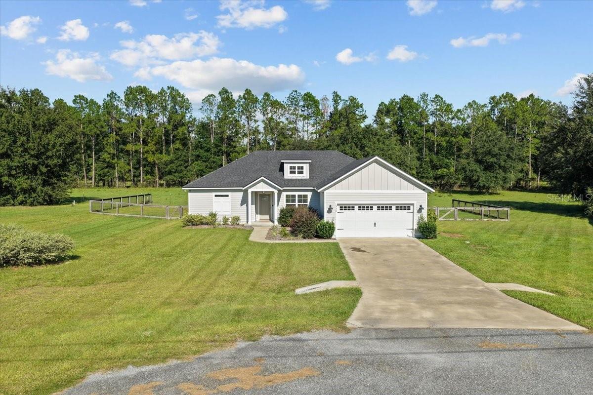 Welcome to this 2019-built home, perfectly situated at the end of a quiet cul-de-sac, located in Cannon Creek Place Subdivision! This stunning 4-bedroom, 2-bath home sits on a 0.52 acre lot in a family-friendly neighborhood with no HOA! Sitting at nearly 1,800sqft, this home provides room for endless possibilities - use the fourth bedroom as an office, reading nook, or home gym! As you step inside you will find a spacious and open floorplan, an oversized kitchen island and seating, and high end luxury vinyl plank flooring throughout. The open-concept design and split floor plan offer a great flow, while the attached two-car garage (21x23) adds extra functionality. The kitchen also features quartz countertops, quality all-wood cabinetry, and stainless steel appliances. Two full baths with tile floors & showers and quartz counters! The master bath has his & hers walk-in closets, a private toilet room, dual vanity sinks, and a tiled walk-in shower! A few other bonuses include upgraded fans throughout, craftsman trim that shows the builders true attention to detail, and decorative lighting that warms up the space perfectly! This home has a fenced backyard with outdoor hanging lights, two covered porches (front 6x8/back 8x16), and a relaxing pasture view where you can sit and watch the sunrise each morning! Pest control sprays every 2 months. This home offers easy access to Lake City and I-75 for commuting. Columbia County is known for its beautiful freshwater springs and lakes, a historic downtown area where residents can enjoy local shopping, dining, and community events, and two premier golf courses. Property has been surveyed. This home will not last long! Call today to schedule your private showing!