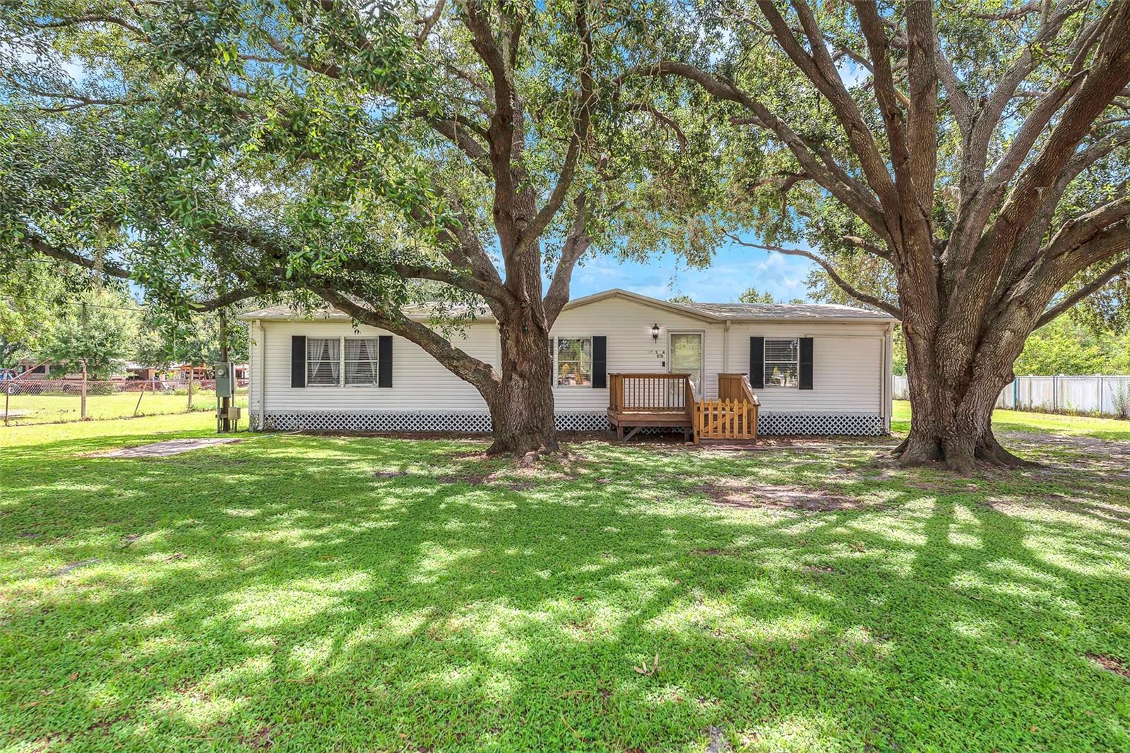 NO HOA & NO CDD!! Nicely maintained manufactured home with 3 bedroom and 2 baths sits on .66 Acres of land. Plenty of room to park your boat, RV and other toys. The home has updated bathrooms, a large primary suite and a spacious 17'x10' covered side porch. Some notable upgrades include 4 Brand New Split A/C systems 2025, New Hot Water Tank 2025, New Electric Panel 2025, & main Septic Tank just pumped out July 2025. There is a 40'x11.5' pad out back to park your RV or even to build an ADU. That pad has a separate electric meter, it's own septic tank, and a water hookup. There is also another nice size concrete pad where a shed once stood at 24'x12' with available electric. Property is completely fenced with front entry gate and located on a quiet cul-de-sac. Come and check it out that feel of country living all within minutes of shopping, restaurants, hospitals and access to I-75, 301 for an easy commute.