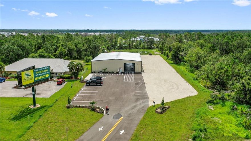 BRAND NEW STEEL BUILDING! Just completed 6/2023. Located one mile East of I75, exit 170 Kings highway, Port Charlotte. This clear span 7500 sq ft property, with 17 ft eave height, has been built to withstand 170 MPH wind. Perfect for use as a warehouse or retail space. Completed in June of this year, the building features a 75 x 100 ft layout on 1.92 acres with 29 parking spaces, paved and nicely landscaped. Access to the building is facilitated by two 14 x 16 overhead doors, one front and one rear, enabling easy drive-through for semi-trucks. While currently wired for single-phase electricity, three-phase power is readily available for installation. In addition to the main building, there is a fenced area measuring 50 x 70 ft, adding 3500 sq. ft. of outdoor storage. The area is enclosed with an 8 ft tall fence and secured by a 20 ft cantilevered gate, providing optimal security for stored items. Inside the building, there is a designated office space measuring 560 sq. ft., complete with two restrooms, a kitchenette, 2 sliding customer/service windows and engineered hardwood flooring. The bathrooms are tiled with FRP walls, ensuring durability and easy maintenance. For added security, the property is equipped with security cameras. Zoned GC for commercial and business, this property presents a remarkable opportunity as buildings of this size and quality rarely become available. With its prime location and excellent features, this property offers the perfect chance to get your business up and running in a matter of days, rather than years. Do not delay and miss out on this exceptional opportunity!