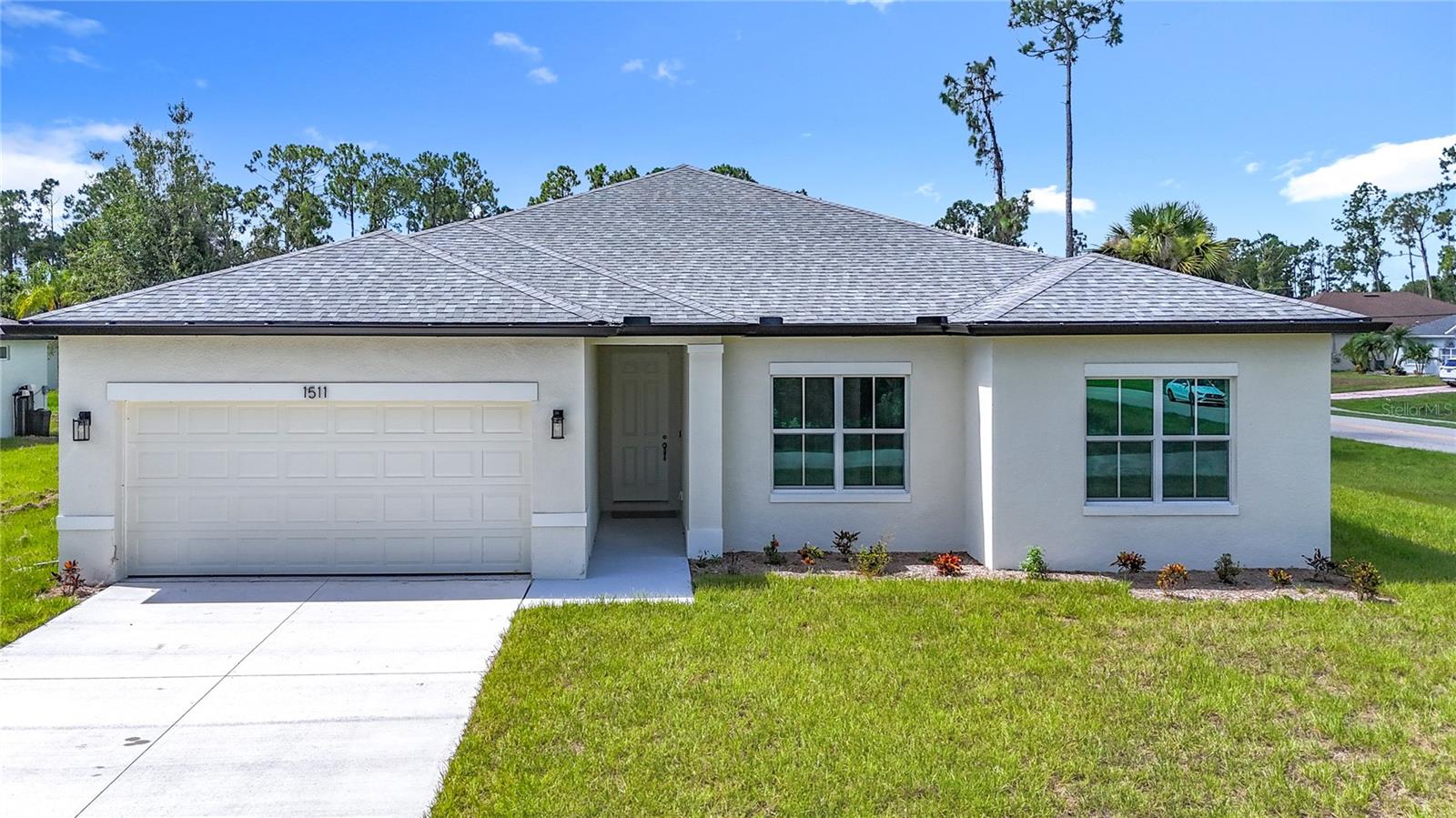 Completed and move-in ready. This concrete block 4-bedroom 3-bathroom 2 car garage home boast a modern design with high ceilings and features an open spacious floorplan design. With an awesome gourmet-inspired kitchen that features white cabinets with a large center island and subway backsplash and upgrades that include Stainless-steel Samsung appliance package with washer and dryer. Also, from the kitchen walk out onto the spacious lanai through the french doors. Water and scratch resistant luxury wood-vinyl flooring throughout the common areas. A spacious master bedroom with tray ceilings, two walk-in closets, a private bathroom with dual vanity area, and large open walk-in shower. Home also features indoor laundry room connecting the attached garage, drop zone cabinet, double pane windows, and a large sliding glass doors that lead out to the open lanai. This brand new home is a must see!