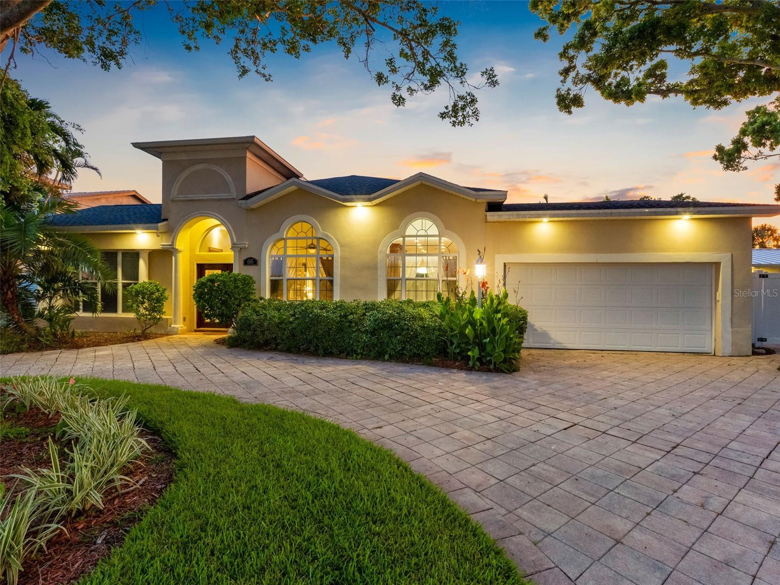 An incredible waterfront setting and elegant design blend beautifully in this special property. Ideally located in the sought-after boater's paradise of Island Estates, this 3BR 3BA pool home is impeccably updated and move-in ready. Thoughtfully designed to create a seamless balance of indoor and outdoor living, this property makes the transition effortlessly. The upgrades begin the moment you enter the dramatic foyer with GORGEOUS polished ceramic tile that has the appearance of natural stone, and high ceilings. The open floorplan is designed to showcase water views from almost every room and includes split bedrooms, office, spacious dining room, and theatre room. The great room is the centerpiece with soaring 12 Ft. ceilings, soft ambient tiered cove lighting, and breathtaking views overlooking the pool and dock. There is also a sound entertainment system integrated into the ceiling of the great room and also throughout the home as well. The gourmet kitchen is perfectly configured for entertaining and features all new appliances including top of the line wood paneled KitchenAid refrigerator, custom wood cabinets, beautiful granite countertops, and spacious breakfast area. When you enter the owner's suite you will find a serene haven with vaulted ceilings, a resort-style en-suite bath that includes a jetted jacuzzi tub, steam shower, high-end fixtures, and HUGE walk-in closet. Just outside is an idyllic oasis of lush tropical landscaping, large pool with lighting and gorgeous paver surround, cabana bath, outdoor kitchen, outdoor dining space, and breathtaking water views. The dock is 2 years new and includes 2 slips that can accommodate 40ft. vessels and a 7000lb. boat lift. It is only minutes from your back yard to the Gulf! No expense was spared in the high-end renovation of this home. New upgrades within the past 9 month include a new roof with transferrable warranty, appliances, and 3 new AC units. Island Estates is a unique enclave that exudes Florida coastal charm and offers easy access to fine dining, shopping, entertainment, banking, Clearwater Marine Aquarium, and award-winning Clearwater Beach! Call now to schedule your tour. Virtual tours are also available.