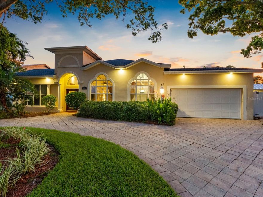 One or more photo(s) has been virtually staged. An incredible waterfront setting and elegant design blend beautifully in this special property. Ideally located in the sought-after boater's paradise of Island Estates, this 3BR 3BA pool home is impeccably updated and move-in ready. Thoughtfully designed to create a seamless balance of indoor and outdoor living, this property makes the transition effortlessly. The upgrades begin the moment you enter the dramatic foyer with GORGEOUS polished ceramic tile that has the appearance of natural stone, and high ceilings. The open floorplan is designed to showcase water views from almost every room and includes split bedrooms, office, spacious dining room, and theatre room. The great room is the centerpiece with soaring 12 Ft. ceilings, soft ambient tiered cove lighting, and breathtaking views overlooking the pool and dock. There is also a sound entertainment system integrated into the ceiling of the great room and also throughout the home as well. The gourmet kitchen is perfectly configured for entertaining and features all new appliances including top of the line wood paneled KitchenAid refrigerator, custom wood cabinets, beautiful granite countertops, and spacious breakfast area. When you enter the owner's suite you will find a serene haven with vaulted ceilings, a resort-style en-suite bath that includes a jetted jacuzzi tub, steam shower, high-end fixtures, and HUGE walk-in closet. Just outside is an idyllic oasis of lush tropical landscaping, large pool with lighting and gorgeous paver surround, cabana bath, outdoor kitchen, outdoor dining space, and breathtaking water views. The dock is 2 years new and includes 2 slips that can accommodate 40ft. vessels and a 7000lb. boat lift. It is only minutes from your back yard to the Gulf! No expense was spared in the high-end renovation of this home. New upgrades within the past 9 month include a new roof with transferrable warranty, appliances, and 3 new AC units. Island Estates is a unique enclave that exudes Florida coastal charm and offers easy access to fine dining, shopping, entertainment, banking, Clearwater Marine Aquarium, and award-winning Clearwater Beach! Call now to schedule your tour. Virtual tours are also available.