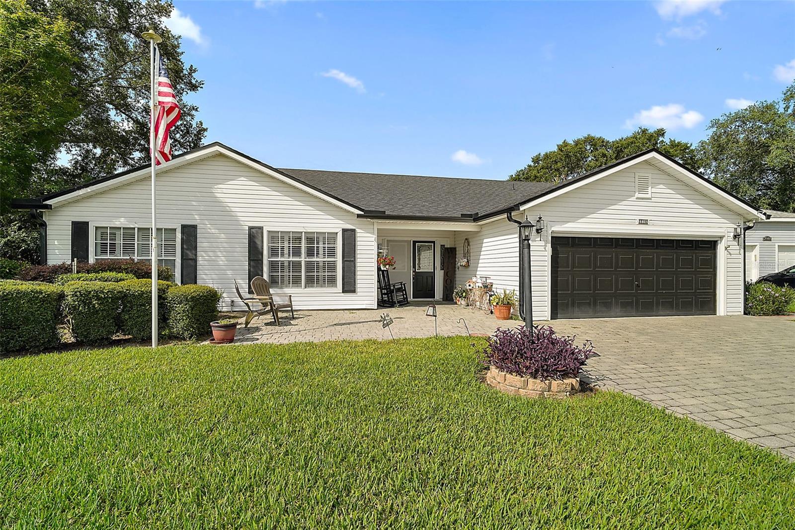 Welcome to Your Dream Home in a Premier Gated Active Adult Golf Community! Step into comfort and style with this beautifully updated 2-bedroom, 2-bath home, nestled in one of the area's most sought-after 55+ golf communities. From the moment you arrive, you'll be greeted by charming curb appeal with a brick paver driveway, a welcoming front patio, and elegant double-door entry. Inside, you'll find upgraded wood laminate flooring flowing throughout, setting the tone for a fresh and modern interior. The spacious floor plan includes an oversized bonus room—perfect for entertaining, hobbies, or relaxing with guests. Plantation shutters add a timeless touch and let in just the right amount of natural light. Heart of the home is the warm welcoming kitchen open to dining and ideal for gatherings. Stunning primary bathroom, thoughtfully remodeled with a large walk-in tiled shower, dual shower heads, and an updated vanity that offers both style and function. Enjoy Florida living year-round in the large enclosed lanai with ceramic tile flooring, or step out back to your expansive rear brick paver patio with sweeping views of the golf course—a perfect setting for morning coffee or evening sunsets. Additional highlights include a screened garage, updated roof (2022), and a quiet, neighborly location close to all the community’s resort-style amenities. Don’t miss your chance to live the lifestyle you deserve—golf, friends, and sunshine await!