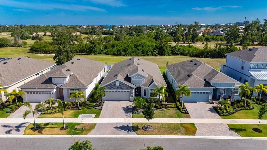 1019 Signet Dr, Apollo Beach, FL 33572 | 4 Bedrooms + Private Office | 3 Bathrooms | 2,359 Sq Ft |  Hampton Floorplan by  | MiraBay

Welcome to 1019 Signet Dr, where a smart one-story Hampton floorplan, a true private office, and finished outdoor living all come together in MiraBay. This 2024 home sits along the retired golf course, giving you wide open green views instead of rear neighbors and a quieter backdrop for daily life.

Inside, the layout is built for how we actually live. You get 4 bedrooms plus a dedicated office at the front of the home, ideal for working from home, homework, or a quiet flex space that does not overlap with bedrooms. High ceilings, crown molding, recessed lighting, and tile throughout the main living areas keep everything feeling bright, clean, and connected.

The kitchen sits at the center of the home and anchors the main living space. An oversized quartz island with seating, 42-inch upper cabinets with crown, tile backsplash, stainless steel appliances, French door refrigerator, built-in oven, gas cooktop with hood, farmhouse sink, and a Culligan water system make it a place you actually want to cook and gather in. The open flow into the dining and great room means everyone stays part of the conversation.

The primary suite is privately positioned at the back of the home with a tray ceiling accented in shiplap and crown, a spacious walk-in closet, and a well-finished ensuite bath. Dual sinks, quartz countertops, an oversized glass-enclosed shower with built-in bench, framed mirror, and linen storage create a space that feels both practical and upgraded. Secondary bedrooms are well sized and split away from the primary, with one bedroom and bath lending itself nicely to guests or an in-law setup.

Outdoor living is where this property really stands out. Sliding glass doors lead to a covered cozy quiet outdoor space that keeps sightlines open to the retired golf course,all set against green space views instead of rooftops.

Curb appeal and exterior details carry the same level of care. A pavered driveway, stone accents, and landscaped beds with curbing give the front elevation a finished look from day one. The 2-car garage provides everyday practicality, and the single-story design removes the hassle of stairs for long-term living.

Living in MiraBay adds another layer to what this home offers. Residents have access to resort-style amenities including heated pools, a clubhouse with fitness center, tennis and pickleball courts, playgrounds, and a full calendar of community events. Golf cart access to MiraBay Village makes dining and daily errands easier, while nearby parks and water access keep you close to the coastal lifestyle Apollo Beach is known for.

With quick connections to US-41, I-75, and US-301,  within reach of Tampa, St. Petersburg, Sarasota, MacDill Air Force Base, sports venues, concerts, and Gulf Coast beaches.