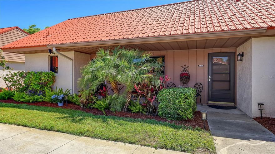 Welcome to your fully renovated slice of paradise in one of Sarasota's most desirable communities in Palmer Ranch! Terrific Value with all of the work done for you and ready for immediate occupancy! This immaculate condo offers an open concept floor plan with a vaulted ceiling in the Living Room with wooden beams. The beautiful furnishings in this condo are negotiable, and it has everything you could possibly need to live comfortably.  The interior is tastefully painted and Seller has done many updates including the following:  Air Conditioner 2023*Water Heater 2020*Metal Roof installed by the association 2012*Washer and Dryer 2026*Dishwasher 2023*Range 2023*Microwave 2023*Refrigerator 2020*Luxury Vinyl Flooring/Showers/Plumbing Fixtures/Baseboards/Paint/Electrical Switches/Kitchen Cabinetry/Granite Tops/Window Tinting/Blinds/Landscaping/Closet Shelving System/Interior Solid Wood Doors (all 2023 & 2024). Additionally, the sewer drain pipe was jetted and relined in 2023. Seller has maintained this condo and it has been barely lived in! There is an inviting Front Porch for seating and a Screened Lanai in the Back that overlooks a water view and many trees. You will love the peaceful setting and you will see wildlife galore! The split floor plan offers 2 bedroom suites with private bathrooms and each has a large walk-in-closet. The custom designed kitchen is done with quality and there is a breakfast bar near the dining room that is perfect for entertaining guests. Step outside and enjoy the maintenance-free living with low HOA fees that cover basic cable TV, trash removal, roof and exterior maintenance, exterior pest control and landscaping. Enjoy all this wonderful community has to provide to you with a sparkling community pool, tennis/pickleball courts, walking trails and captivating water views. Daily conveniences are just minutes away, with grocery shopping nearby as well as fitness centers and fine restaurants. World renowned Siesta Key Beaches are only 15 minutes away and cultural downtown Sarasota is 20 minutes away with fine dining, opera, movie theaters, Selby Gardens & more. You'll also appreciate your own carport space and there is plenty of guest parking. The location of this condo is way in the back so it is nice and quiet and has very little traffic. Make this updated gem yours, but don't wait ... this one won't last long! Hurry before it's gone!