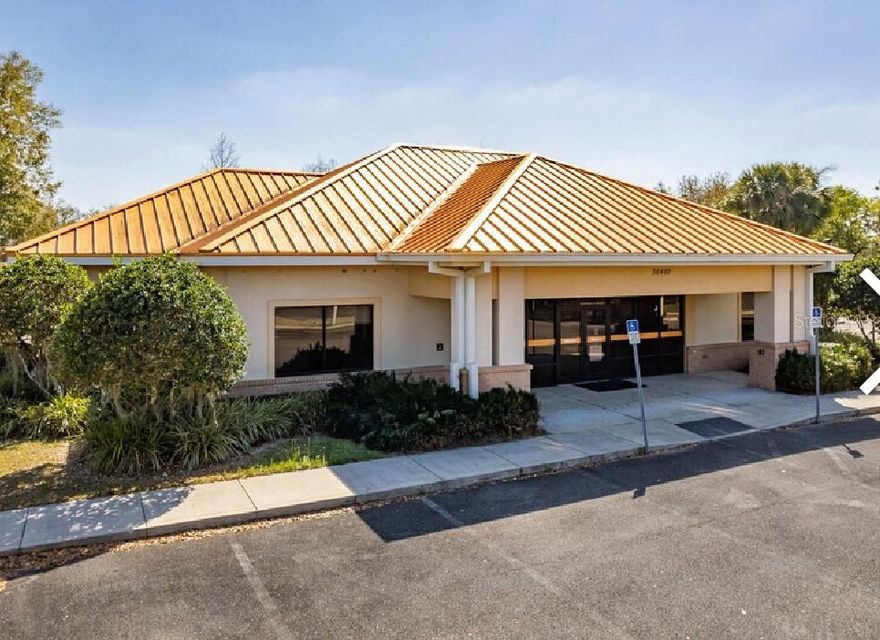 - Former bank building constructed in 2009 and located on the crossing street on Eiland Blvd and Dean Dairy Road. This property includes a drive-thru with plenty of parking.
- EXCELLENT OPPORTUNITY TO PURCHASE A PRIME HARD CORNER PROPERTY WITH AN EXISTING BUILDING ON THE FAST PACED GROWING CORRIDOR OF EILAND BLVD IN THE ZEPHYRHILLS TRADE AREA!!!
- This +/- 4.05 ACRE site features a solid concrete block constructed 2009 former financial services building consisting of approximately 3,756 sq ft of office area, with an additional 3 lane drive thru with 1 bypass lane canopy consisting of another 1,680 sq ft for a total of 5,436 under metal roof.
- Building has an exquisite impressive professional appearance featuring ceramic tile in heavy traffic areas, carpet in offices, several work areas, 3 private offices, two restrooms, breakroom, vault with functioning vault door, teller line with 5 lobby stations and drive thru with 2 teller stations.
- The site also has approximately 1.78 acres of outparcel land to develop future retail or office space up to approximately 43,876 sq ft. Retention is off site making this very desirable to develop, with the frontage road already in place.
- Access points on Eiland Blvd and Dean Dairy Rd via a traffic light controlled intersection. Monument signage in place with the ability to add more.
- Approximately 769 feet of frontage on Eiland Blvd. Commercial neighbors include Circle K, Florida Medical Clinic, Ryals Chase multi family condominiums, and Silverado Golf and Country Club. Great opportunity for an owner user or developer to lease out the existing building and develop the additional outparcel site. ;Water: City