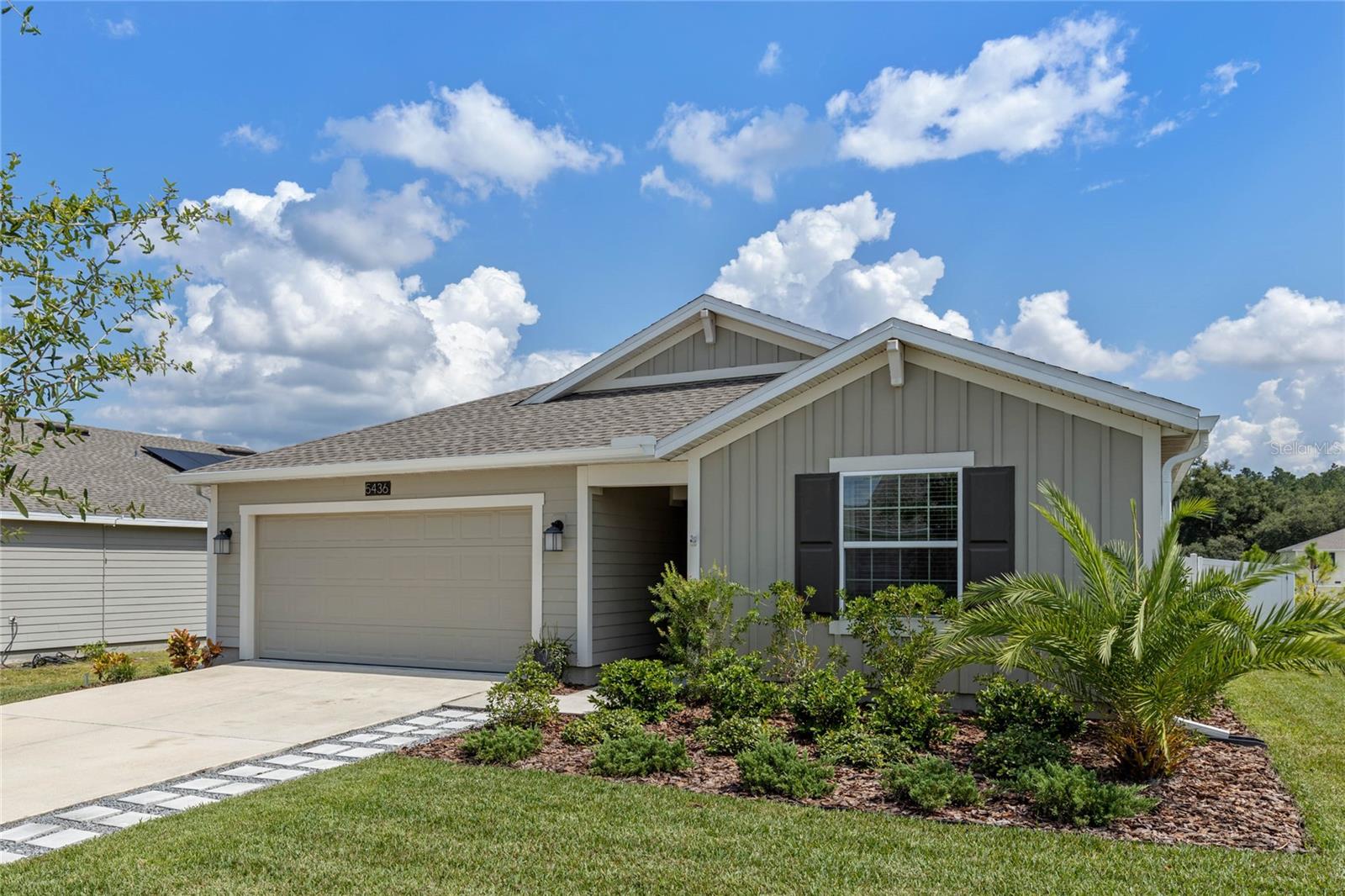 Welcome to your dream home in the sought-after resort style community of Stoneybrook Hills! This beautifully maintained 4-bedroom, 2-bath home was built in 2021 and offers the perfect blend of modern design, functional living, and scenic tranquility. Step inside to an open-concept floor plan filled with natural light and stylish finishes. The heart of the home is the contemporary kitchen, featuring sleek quartz countertops, stainless steel appliances, a large center island, wood-look tile flooring, and a cohesive color palette that exudes warmth and sophistication. The kitchen flows seamlessly into the spacious dining area and inviting living room, complete with elegant built-ins for aesthetics and additional storage. The sliding glass door allows excellent natural light into the common areas and opens to your fenced backyard. The primary suite is a true retreat, offering a generous walk-in closet and a spa-inspired bathroom with dual vanities, upgraded fixtures, and a custom accent wall that adds a touch of luxury. Down the hall, you'll find three additional bedrooms—perfect for family or guests—with bedroom 3 currently serving as a home office, easily converted back if desired. A second full bathroom is conveniently located nearby and with tasteful design as well. Function meets convenience with a sizable laundry room and a 2-car garage just off the kitchen. Step out back to enjoy your back patio, artificial turf play area, and serene views of the pond and surrounding tree line—ideal for relaxing evenings or weekend entertaining. Energy efficiency is top-of-mind with double-paned windows and solar panels, helping keep utility bills low for years to come. As a resident of Stoneybrook Hills, you’ll enjoy premium amenities including: 24/7 guarded entrance, fitness center, pool, splash pad, playgrounds, basketball court, tennis/pickleball courts, and more. Location is excellent with 436 & 414 close by to get to Orlando and surrounding areas. Best of all, you're just 10 minutes from the charm of downtown Mt. Dora, whether you want a dinner spot, coffee shop, retail and historic sites, or weekend farmers market, its all just a few miles away. Come tour this home before it’s gone!