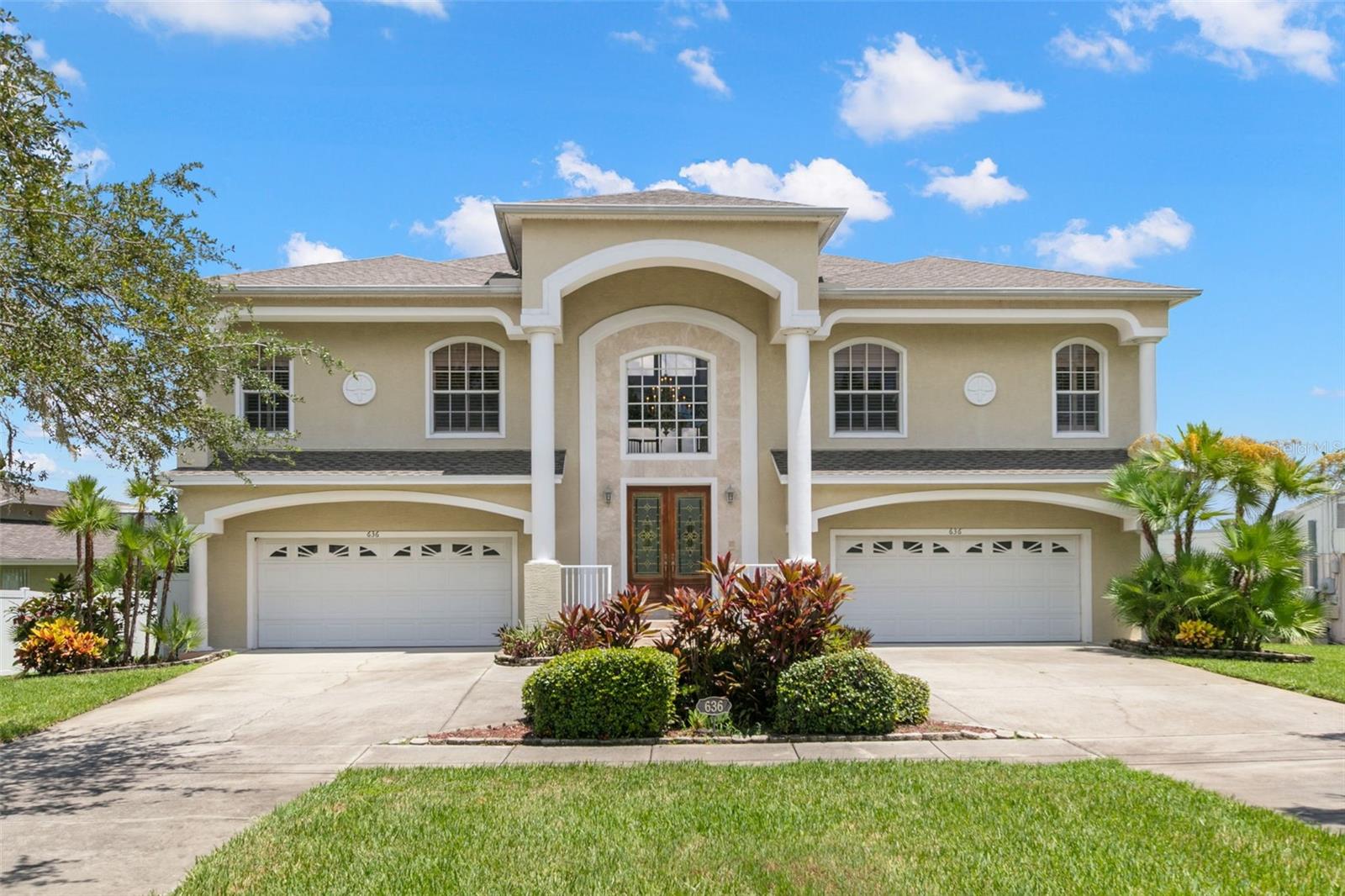 Stunning Waterfront Estate with Pool, Dock, Boat Lift & Two 2-Car Garages – Welcome home to your private waterfront oasis in beautiful Tarpon Springs! This impressive property features a circular drive, two separate 2-car garages, and endless room for cars, toys, and watercraft. With an elevator, two full living levels, and breathtaking water views from nearly every angle, this home offers luxury, space, and the ultimate Florida lifestyle. Step inside the double-door entry to your grand two-story foyer with chandelier, then head downstairs to the versatile ground floor. Expansive bonus/family room with sliding door access to a screened porch overlooking the in-ground pool that inlcudes a lovely hot tub/spa! Enjoy an efficiency kitchen for poolside entertaining - there is a breakfast bar, refrigerator, microwave, sink and dark wood cabinetry. The first-floor bedroom has a walk-in closet, water views, and private porch access. The full bath with step-in shower offers direct pool access. There are two oversized storage closets as well. From the porch, follow your private walkway to the dock, complete with sink, electric, covered 20,000 pound boat lift, and jet ski lift—perfect for launching right into Florida’s waterways. Use the stairs or elevator to your main living level where you can enjoy the elevated living with panoramic views that will take your breath away. The expansive living room offers high-volume ceilings, pocket sliders to the screened porch, ceiling fans, recessed lighting, gas fireplace, and custom built-ins. The large screened lanai is ideal for outdoor dining and relaxing. Your primary suite is accessed via double-door entry. There are amazing water views and private access to the lanai, two oversized walk-in closets and a spa-like en suite with dual vanities, Jacuzzi soaking tub, oversized step-in shower with bench, and a private water closet with linen storage. Your kitchen boasts white cabinetry, granite counters, and decorative tile backsplash. There is a breakfast bar, breakfast nook with stunning water views, and a pantry with pull-out shelving in addition to an oversized pantry closet. The laundry room is separated by a pocket door and offers built-in cabinetry, deep sink, hanging bar, and washer/dryer. The formal dining area has a lovely chandelier and arched architectural details that open to the grand foyer. The two additonal bedrooms are generous in size. One boasts two wall closets while the other has a walk-in closet. The hall bath has a tub/shower combo and there is another linen closet for storage off the hall. Your outdoor paradise includes a screened lanai with water views, in-ground pool with gated fence and your private dock. Located just minutes from Tarpon Springs historic sponge docks, beaches, dining, and entertainment, this property blends luxury living, unmatched storage, and world-class boating access into one stunning package. Schedule your private tour today and start living your best Florida life!