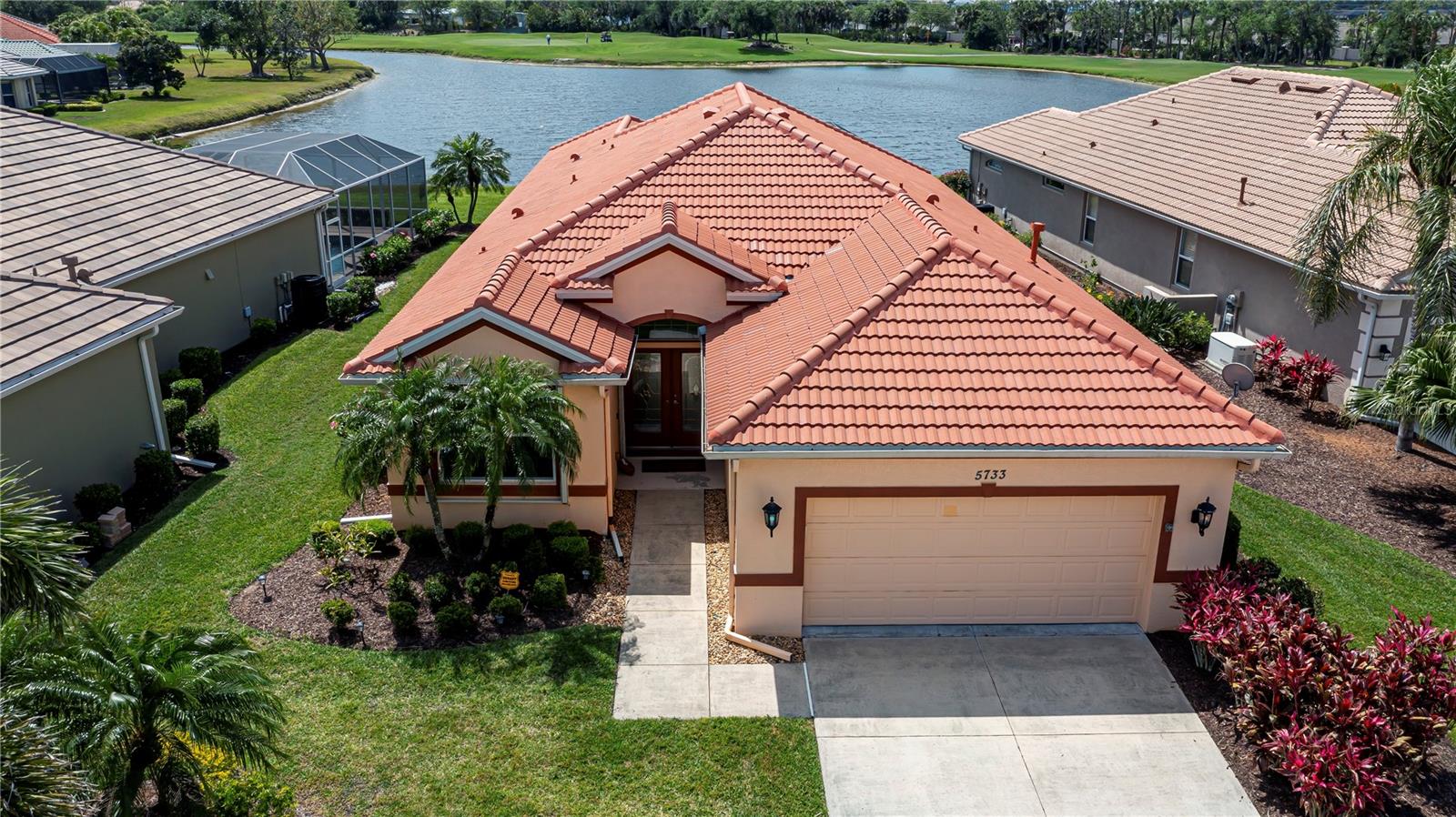 PANORAMIC LAKEFRONT VIEWS plus PREMIER 6th green GOLF VIEWS on a tranquil CUL-DE-SAC will astound you with this CUSTOM 3/2/2 POOL HOME in the sought after GATED community of HERON CREEK GOLF & COUNTRY CLUB plus TURNKEY FURNISHED! Boasting a southern exposure ,spectacular curb appeal, soaring covered entryway, designer inspired double glass door entry topped with its own sunburst window, lush landscaping, plus extended driveway...this 2228 sq ft David Schroeders built split plan has abundant natural light and ENDLESS SCENIC VIEWS from most rooms and is IMPRESSIVE. A spacious OPEN CONCEPT Great Room allows for effortless entertaining, while upgraded TRAY and volume CEILINGS create ambiance complimented by easy care tile floors set on a diagonal throughout. A chef worthy kitchen will delight all your culinary senses*** granite countertops, top of the line VIKING SS appliances including a 6 burner NATURAL GAS COOKTOP and built in DOUBLE OVENS ,professional range hood, tiled backsplash, beautiful cabinetry/drawers, full sized pantry, custom breakfast bar and its own separate dining room accessorized with complimentary buffet base and a deco mirror enclave ready to showcase your decor. The master bedroom, a modern day sanctuary overlooks the VAST LAKEFRONT, with two walk in closets, lovely tray ceiling and ensuite bathroom with ROMAN shower, dual sinks/vanities and private commode speaks soothing tones of relaxation. Both guest suites are also spacious and share a nicely appointed middle bath with the rest of the main home. Dual glass sliding doors brings the outside in seamlessly, a personal oasis with calming unobstructed views from an upgraded “CLEARVIEW SCREEN”. Swim, lounge, or just take it easy relaxing and enjoy the waterfront/golfing lifestyle up close and personal day or night, this HUGE sparkling freeform swimming pool will be a favorite with its never ending views. Easy care accordion shutters, NEW ROOF, new pool pump, newer water heater and A/C , inside laundry and large 2 car garage adds convenience and peace of mind. Enjoy the LOW quarterly HOA fees that include secure gate entry, cable, internet, ground maintenance, irrigation, and mulching, with NO CDD and located in Flood Zone X, so no flood insurance is required. Residents of this exclusive gated community enjoy a wealth of premium amenities, including a spacious 21,000 sq ft clubhouse featuring both casual & fine dining, modern fitness center, heated resort-style pool/spa, tennis courts, and an exceptional short-game practice facility.Heron Creek Golf & Country Club’s impressive clubhouse has a wide range of social activities, an excellent practice facility plus a 27-hole championship golf course designed by Arthur Hills with membership available beginning at just $268 per month.Ideally situated near the top beaches of Southwest Florida, shopping, parks, and provides convenient access to I-75 and US-41. Heron Creek is only a short drive to downtown Venice, Wellen Park, the Braves stadium, the new SMH healthcare facility,Cool Today Park, Warm Mineral Springs and local airports. This home perfectly blends luxury with everyday convenience…DON’T MISS OUT—this gorgeous LAKEFRONT POOL HOME is waiting for you!