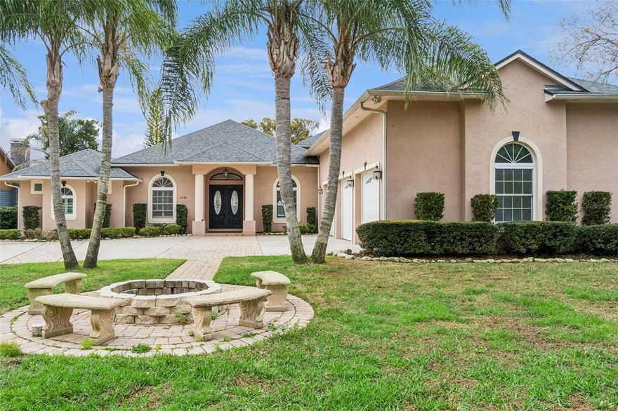 Tucked beneath majestic oak trees and set on nearly an acre of lakefront property, this custom-built estate offers a rare blend of privacy, space, and waterfront living on Lost Lake (also known as Coon Lake), part of the highly sought-after Alligator Chain of Lakes.
Built in 2008, the property includes a beautifully designed main residence and a detached guest apartment, with a total of 5,297 square feet of living space and over 8,100 square feet under roof. The main home features four bedrooms, three and a half bathrooms, and a three-car garage, with thoughtfully designed living spaces and a private 2nd-floor balcony that captures peaceful lake views from multiple vantage points.

Inside, the home balances comfort and function with generous gathering areas, a gas fireplace, a formal dining room with a coffered ceiling, and an updated kitchen completed in 2024 with new granite countertops, backsplash, Z-Tech cooktop, and double ovens with wireless controls. The spacious primary suite offers two large walk-in closets, one of which is constructed as a reinforced safe room, and a spa-style bath with a hydromassage tub, dual vanities, and a separate shower.

Upstairs, the home offers additional flexibility with a large bonus/game room and a private home theater, complete with projector, screen, and sound system, all included with the sale.

A standout feature of the property is the detached guest residence, located above a second three-car garage. This approximately 1,200-square-foot apartment includes a full kitchen, living room, dining area, oversized bedroom (with potential to convert to two bedrooms), and a full bathroom, along with a convenient half bath on the garage level. It provides an ideal space for extended family, guests, rental, or private workspace.

Outdoor living is equally impressive. The expansive lanai and patio areas offer approximately 1,500 square feet of covered and open space,
creating the perfect setting for relaxing or entertaining while enjoying tranquil lake views. The backyard also features a custom koi pond with waterfall and approximately 30 koi fish valued between $10,000 and $15,000, adding a unique and peaceful element to the landscape.

For boating and water enthusiasts, the property includes a private dock with a boat lift and new lift motor, providing direct access to the Alligator Chain of Lakes for fishing, boating, and recreation.

Major updates include a new roof in 2024, a new main HVAC system in 2024, a second Carrier Infiniti HVAC system, approximately six years old, and updated drain lines.

With two separate three-car garages, no HOA, mature landscaping, fruit trees, and nearly an acre of lakefront land, this property offers a rare opportunity to enjoy expansive waterfront living while remaining conveniently close to Harmony, Melbourne, St. Cloud/Lake Nona regions.