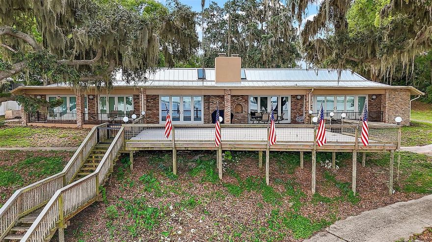 This is one of the most unique homes you will ever find/see - the owners were in the process of a complete make over to a very high-level upgrade of everything, they completed the inside and the deck, dock and boat house - then due to heath issues decided to sell this fantastic home. When you enter the entrance, you are in the Kitchen of a great room that looks like an artist just finished with the painting and color coordination of everything, yet it feels like you just entered your home (a very comfortable and warm home).This home feature top line appliances - unbelievable Lake Weir view (best I have ever seen) - High ceilings Lage master bedroom suite - The deck is large and very interesting (you need to see to get what I'm trying to say - the dock and boathouse - the beach area is inviting and very nice, scenic and usable. There is only one way to experience all that this lake home offers, call and get a private tour. Truly a one-of-a-kind property