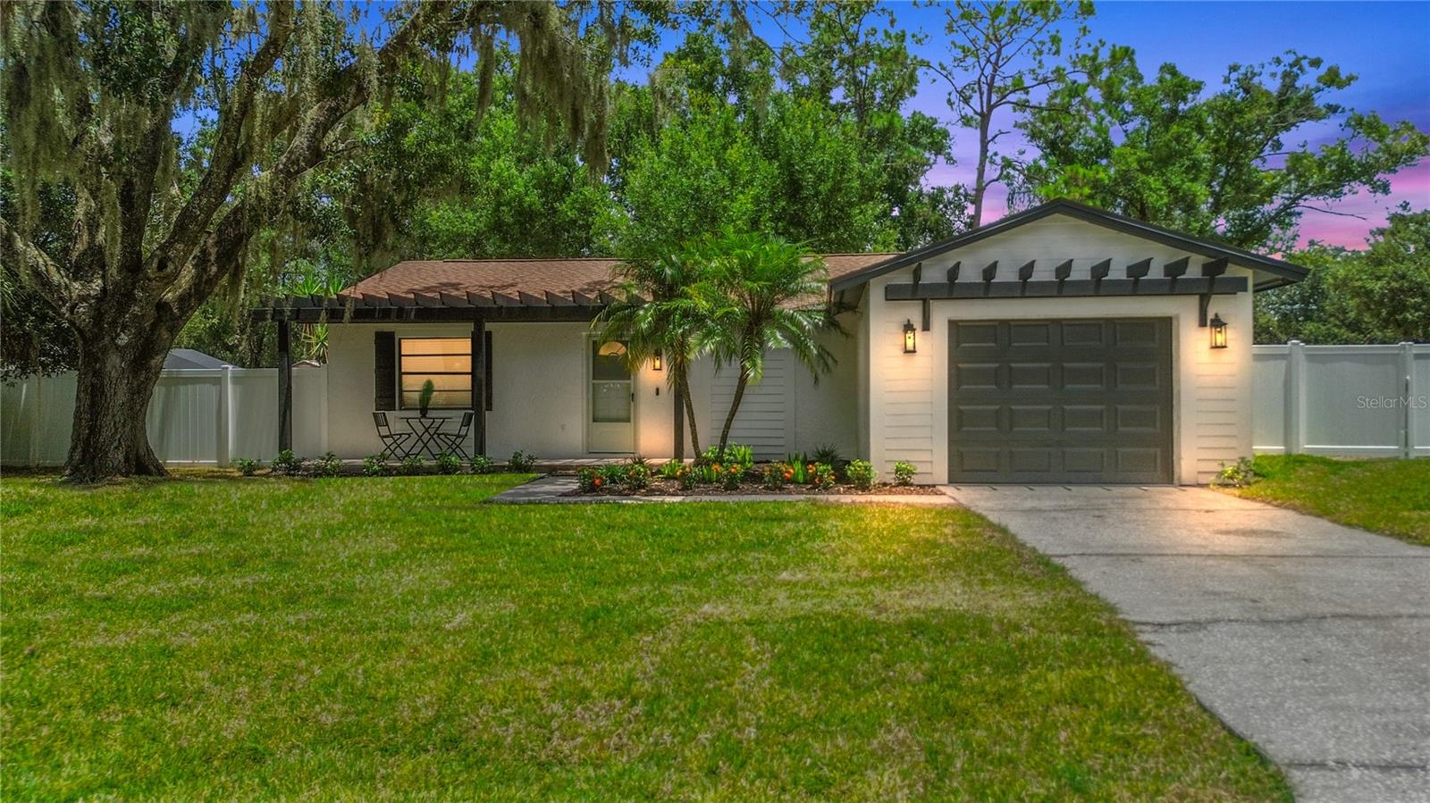 Better than brand new—this beautifully renovated 3-bedroom, 2-bathroom home with a 1-car garage is bursting with custom features and charm. Renovated with love from top to bottom, it offers everything brand-new from flooring, fixtures, appliances, designer details throughout, including custom wall paneling and a built-in coffee bar for your morning routine and so much more. The open living area features a real wood-burning fireplace, creating the perfect cozy focal point. The brand new kitchen includes all new appliances, and there’s even a second refrigerator in the garage for extra storage. A washer, dryer, and laundry sink are also included. Step outside to enjoy the tiled, screened-in lanai with a brand-new outdoor kitchen featuring a griddle, egg grill, stovetop, and refrigerator—ideal for entertaining year-round. The oversized, fenced yard is freshly sodded and includes a custom-built pergola and fire pit. The front porch is also tiled for added charm, and there’s gated side yard access with space to park your toys. Pet-friendly and full of thoughtful upgrades, this home is located in the sought-after Lake Padgett Estates East. Residents enjoy a community pool, clubhouse with restaurant, tennis and racquetball courts, basketball courts, jogging track, and a playground. Stylish, functional, and full of heart—don’t miss your chance to make this stunning home yours!