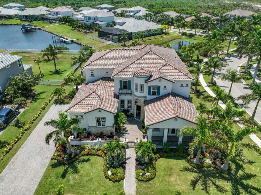 Welcome home to the coveted Bay Estates Preserve located in the exclusive waterfront community of MiraBay. This luxurious home features nearly 6,000 sq.ft. with 6 bedrooms, 5 full bathrooms and 2 half baths, study, bonus room, theatre and 3 1/2 car garage. This is truly a "one of a kind" custom dream home designed with elegance, style and entertaining in mind. As you arrive you will be greeted by a gorgeous 2 story home situated perfectly on a half acre waterview lot with lush tropical landscaping, and the enchanting front courtyard with two separate gated walkway entrances. Step into the lofty 26 ft foyer noting real limestone. The iron work and glass front entry door is astounding. Above the foyer you will find a Juliette balcony with abundant morning natural light. The home boast soaring 12 ft ceilings and hardwood maple floors throughout. The feeling is surreal on the first floor offering a custom wine cellar with handcrafted mahagony wine racks, illuminated by antiqued chandeliers. The formal dining room is decorated with crystal chandeliers, a tray ceiling with a Butlers pantry leading to the extravagant chefs kitchen, adorned with quartz counters including an impressive 10 ft center island. The 42" soft close cabinets and drawers allow for ample storage and ease of use. The mosaic backsplash makes a timeless statement with high quality marble with mother of pearl inlays imported directly from the quarries of Greece. Other amenities include all "Smart" stainless steel Samsung appliances, oversized double door fridge, built in double oven, microwave, cooktop, two valve pot filler, maple wood Zline dual blower range hood and a matching stainless steel farmhouse sink. The great room includes a grand windmill ceiling fan, recessed lighting, a decorative accent wall with triple sliding glass doors offering lavish views of paradise. The master bedroom is captivating with a tray ceiling, an impressive ensuite bathroom having both his and her walk in closets, dual quartz vanity sinks, satin nickel fixtures, soaking garden tub, separate walk in rain shower, exquisite Swarovski chandeliers, and a separate room/study. You will find an elegantly secluded private dog room beneath the stately staircase. Second floor features a stellar bonus room with a wet bar, Thor under counter double fridge drawers, and french doors leading to the magnificent waterviews. Movie night in the theatre room is sure to be sensational "not to disappoint" with Atmos speakers, 150"screen with a 4k projector, stadium seating and torch lighting. There are four exceptionally large bedrooms with ensuite bathrooms, recessed lighting, dual vanities, brush satin nickel fixtures, and porcelain tile flooring in all wet areas. Juliette balcony off one of the bedrooms allows for some book reading and connects your guest to the rest of the house. Laundry rooms are conveniently located both up and downstairs. The garage matches the exquisite taste of the home, with a designer 6 layer epoxy floor, artistic car emblems, and the doors painted by Jacksonville artist for a faux wood finish. Accessories include dedicated 50 amp circuit level 2 electric car charger, and ceiling storage racks. The home also includes a whole house water softener and purification system. MiraBay amenities: clubhouse, basketball, tennis and pickleball courts, fitness center, resort-style Olympic swimming pool, water slide, playgrounds, parks, gym, and much more.