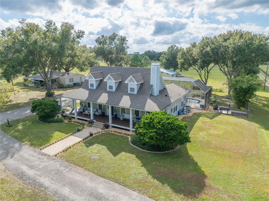 Priced below appraised value, this exceptional Multigenerational property spans approximately 10 acres with 2 homes across 2 separate parcels which may be financed separately and offers the ideal blend of country living and convenient access to modern amenities. Many updates and improvements. Located just minutes from I-4 down a tree-lined drive, the estate features two ponds and a private ATV track. The 3479 sq. ft. primary residence is a beautifully appointed 4-bedroom, 3.5-bath home with a bonus room and tons of upgrades. Not included in the listing details you will find a 3 bedroom, 2 bath 1300 sq. ft. Guest House.  As you enter the property, a wraparound front porch welcomes you, while the rear features a sparkling heated saltwater pool and spa with waterfall, all enclosed in a high screen with Pentair smart controls (new in 2025). Expansive windows flood the interior with natural light, enhancing the open, airy layout perfect for both everyday living and entertaining.  The living room includes a wood-burning fireplace and flows into the formal dining room and spacious kitchen/family room combo. The kitchen features updated Samsung appliances, including a double oven and French door refrigerator, along with a new downdraft cooktop and water heater (2025). Open to the kitchen is the comfortable nook and family room with access to the back patio. Follow the open gallery/hallway to the powder bath and the primary suite which offers a renovated bath with antique clawfoot tub, updated shower, and dual walk-in closets. Two additional bedrooms and hall bath complete the first floor, while the upper level hosts a second suite, bath, and bonus room or office.  The Guest House at 1934 Holy Cow Rd (not reflected in the listing information room count and square footage), is a 3-bedroom, 2-bath Skyline manufactured residence that offers flexibility for extended family or rental income. Recent 2025 upgrades include new plumbing, skirting, and a drain field system.  Additional structures include a versatile Garage/Workshop divided into five functional spaces, two of which are air-conditioned, plus a pump room & a lawn storage room, along with a separate single wide storage building with restoration potential. The property is internet-ready with Spectrum service available and current Starlink setup. All information & property details are deemed reliable but not guaranteed & Buyer/Buyer's Agent is responsible for their own due diligence including but not limited to verifying County restrictions & uses, Leasing Requirements, Building Sizes, Lot Size, Room Dimensions, & Taxes. Buyers should consult Polk County Planning & Development to confirm property uses and restrictions.