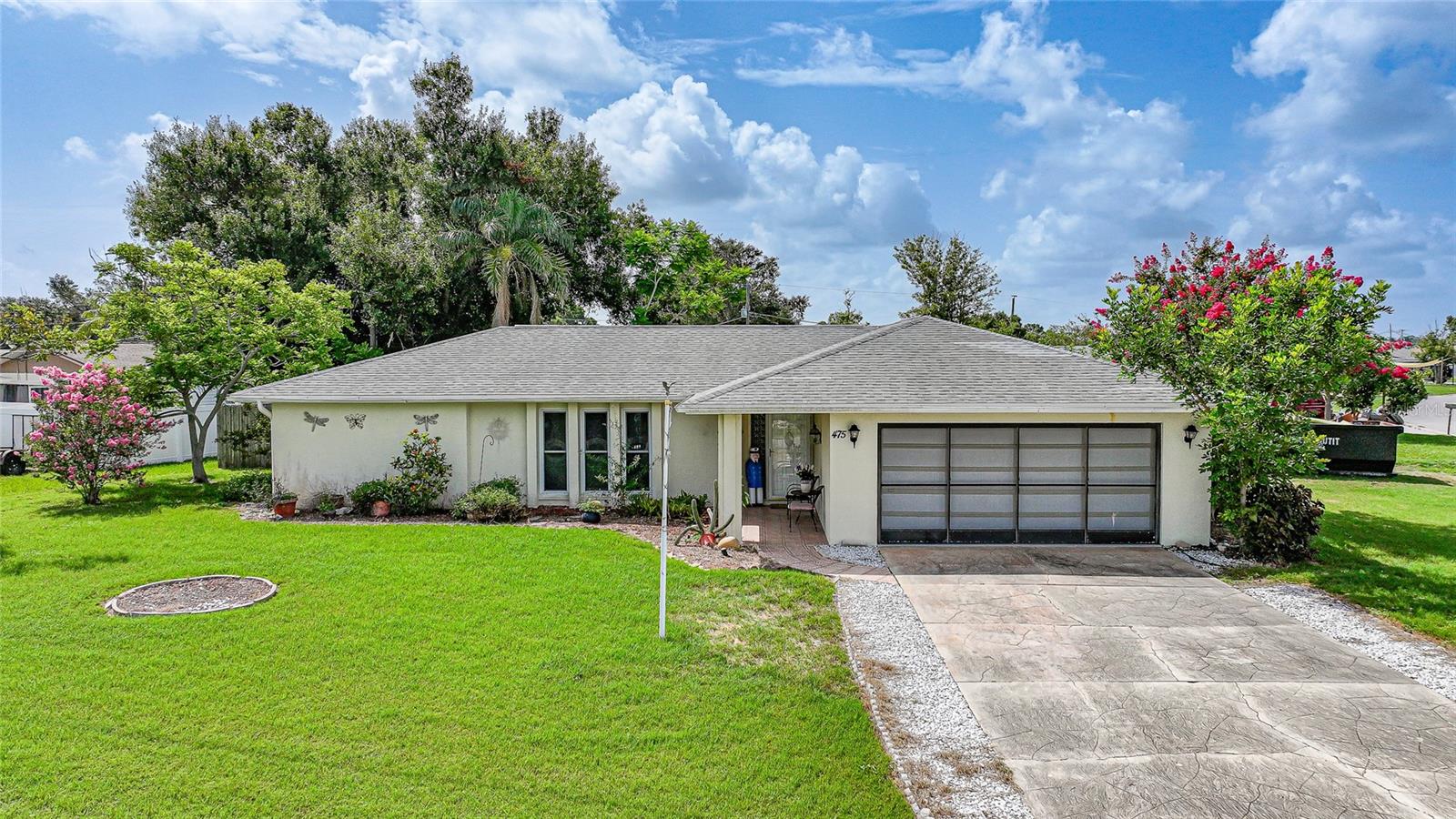Tucked away on a spacious corner lot in beautiful Venice, Florida, this delightful 2-bedroom, 2-bath home with a bonus room and 2-car garage blends comfort, charm, and functionality in one well-maintained package. Thoughtful updates provide lasting value, including a NEWER A/C system (2017), upgraded electrical panel (2018), and durable, easy-care Formica countertops throughout the kitchen. Offering 1,339 square feet of light-filled living space, this home is designed for both relaxed living and easy entertaining. IMPACT WINDOWS are installed throughout the entire home, offering added peace of mind and energy efficiency. The bonus room adds flexibility—perfect for a home office, reading nook, craft room, or guest overflow. The main living area flows comfortably into the dining space and kitchen, giving the home an open, airy feel. The primary suite is a peaceful retreat, complete with a tub and shower combo and a generous walk-in closet. The second bedroom is just as inviting, featuring its own private ensuite bath and another walk-in closet, making it ideal for visiting guests or multi-generational living arrangements. An indoor laundry room adds everyday convenience and keeps chores out of sight. Step outside to enjoy your fully fenced backyard, a private oasis with plenty of room for pets, play, or gardening. You’ll also love the 330 square foot lanai—perfect for relaxing, entertaining, or enjoying Florida’s beautiful weather year-round. Two sheds offer ample storage for tools, bikes, or beach gear, and the corner lot adds curb appeal and extra breathing room. A roomy 2-car garage completes the picture, giving you the space and storage every Florida home needs. Located in a quiet, established neighborhood with easy access to shopping, dining, golf courses, and the white-sand beaches Venice is famous for, this home is perfect as a full-time residence, seasonal getaway, or smart investment opportunity. Don’t miss your chance to enjoy the Florida lifestyle in a home that truly has it all—schedule your private showing today!