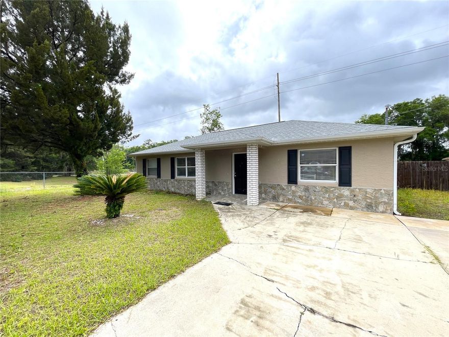 This beautiful three bedroom, two bathroom home (NEW 2023 Roof) sits on a large 0.36 acre lot in the quiet Tabor Park area of North Ocala. The moment you walk in, you notice the open space and the clean modern look. It feels fresh, bright, and easy to live in. The floors are bright solid tile through the main kitchen and living area of the home so there is no carpet to worry about. The kitchen is the heart of the home. Imagine cooking dinner while talking with family or friends in the living room. The granite countertops shine, the cabinets give you plenty of space, and the brand new stainless steel appliances make everything feel new and ready for you. The split bedroom layout gives everyone their own space. The primary bedroom feels calm and private, while the other bedrooms are perfect for family, guests, or even a home office. Step outside and the possibilities really open up. The backyard is fenced and huge. Picture weekend cookouts, dogs playing, or planting your own garden. There is even a storage shed for tools, toys, or hobbies. With a lot this big you still have room to dream bigger. Major updates are already done for you. A brand new roof sits overhead (done in 2023). Fresh interior paint makes the whole home feel clean and bright. Central air keeps you cool during Florida summers. And the best part. There is no HOA. No extra rules. No extra fees. Just your home and your space. This is the kind of home where memories start. Morning coffee in the quiet backyard. Family dinners that turn into late night talks. A place that is truly yours. All that is missing is you. This won't last long! Book your showing today