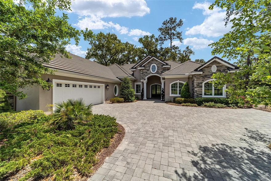 Turnkey luxury living in Golden Ocala Golf & Equestrian Club, perfectly positioned at the end of a private cul-de-sac overlooking the 7th fairway, offering a rare blend of privacy, prestige, and effortless access to the world-renowned World Equestrian Center just moments away. Designed for buyers seeking an elevated lifestyle, this custom residence captures the essence of Ocala’s luxury equestrian market, and offers those who value refined living, exclusivity, and proximity to world-class amenities.
From the moment you enter through the grand double doors, the home welcomes you with a striking foyer featuring stone accents and a seamless flow into the main living spaces. Porcelain tile flooring extends throughout, complemented by crown molding, designer lighting, and a statement stone fireplace that anchors the living area. Expansive windows frame sweeping golf course views while filling the home with natural light, creating an inviting yet sophisticated atmosphere ideal for both everyday living and entertaining.
The kitchen is thoughtfully designed to meet the expectations of the most discerning buyer, featuring a spacious island, custom cabinetry, elegant lighting, and high-end appliances that blend functionality with refined design. The adjacent dining and living areas offer a seamless connection to the outdoors, enhancing the home’s open-concept layout and lifestyle appeal.

The primary suite is a private retreat, offering dual walk-in closets and a spa-inspired bath designed for relaxation and comfort. Every element of the home reflects quality craftsmanship and attention to detail, creating a true turnkey experience.

Outdoor living is equally impressive, with a beautifully designed lanai featuring a full outdoor kitchen, generous dining and lounge areas, porcelain tile flooring, and a screened enclosure that allows for year-round enjoyment. The backyard is fully fenced with privacy hedges and meticulously landscaped grounds, enhanced by a professionally designed outdoor lighting system with automated astronomical timing that creates a stunning ambiance in the evening hours.
Additional features include a whole-house Generac generator, offering peace of mind and convenience. Located within Golden Ocala, one of the area’s most prestigious gated communities, this residence provides unmatched access to championship golf, fine dining, and the vibrant lifestyle surrounding the World Equestrian Center.
Move-in ready and designed for effortless luxury, this home presents an exceptional opportunity to experience the very best of Ocala’s golf and equestrian lifestyle.