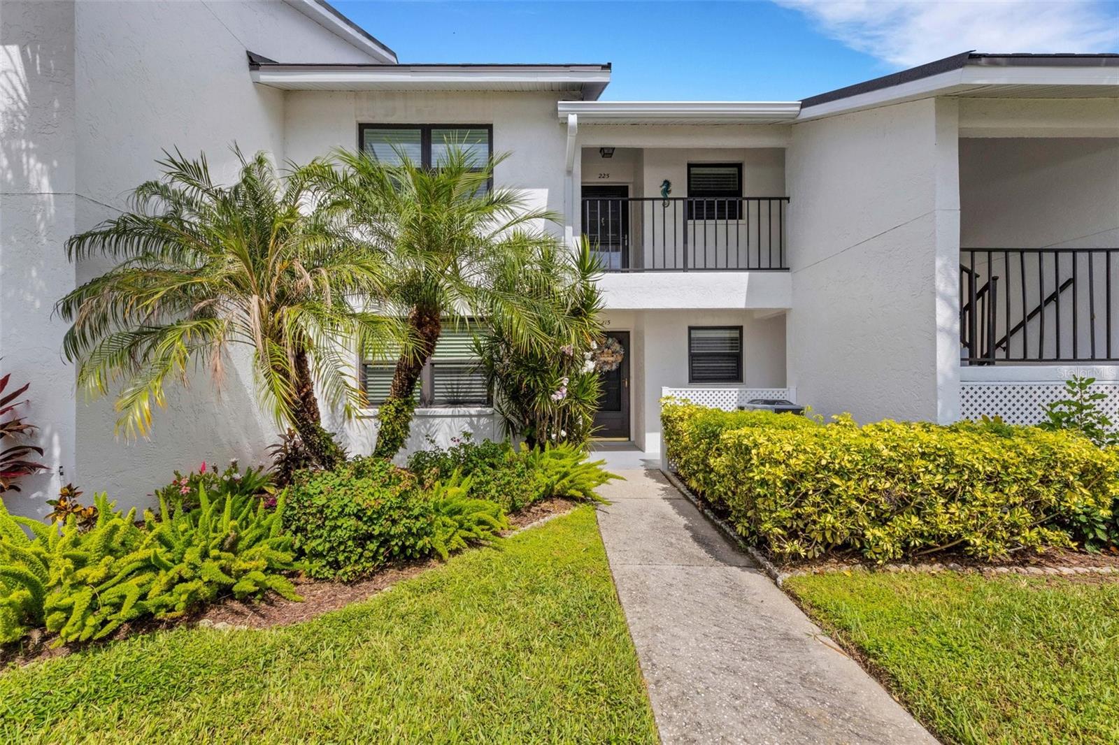 LAKES OF CAPRI'S highly desired Building 2,GROUND FLOOR with its PEACEFUL WATER VIEWS and a backdrop of beautiful rich green mature foliage. You will enjoy your time watching the birds by day and spectacular sunsets by night. This rich and inviting TURNKEY unit is bright and airy. This unit has been meticulously maintained. Entertaining will be a breeze with the convenient pass through from the kitchen to the dining room. The living room and dining room flow together for that open concept and feature a built in dry bar/workstation. Sliders off the living room go to the spacious lanai that overlooks the water and the lanai can also be accessed from the primary bedroom as well! The primary bedroom has an en-suite bath, double vanities, walk in shower and a large walk in closet. The second bedroom is perfect for multifamily or overnight guests and the loveseat in the living room opens to a sleeper. There is a stacked combo washer/dryer in the unit so no running to the laundry mat! The owner is leaving the furniture and some kitchen essentials and the garbage disposal and dishwasher were recently replaced. The electric fireplace is the perfect way to chase away those occasional cool evenings. Everything you need to move right in! ALL the buildings have NEW ROOFS (metal shingle), CARPORTS & STORAGE UNITS that were completed 2024 and the roads were just re-surfaced. This unit has hurricane windows and automatic hurricane shutters on the lanai. LAKES OF CAPRI is a beautiful well maintained community with close proximity to everything you need. Shopping, beaches,recreation, hospital, libraries and there is even a public golf course right down the street. We have a stunning heated pool and lounging area that's perfect for gatherings with your neighbors, family and friends. They have a club house and a well equipped work shed that has everything you need for those little fix it jobs around the house. This is everything you dreamed about. It's time to start living the Florida lifestyle!! NO SPECIAL ASSESSMENTS and the Condo Fee's had a price decrease for the last 2 quarters of 2025. This is a MUST SEE!