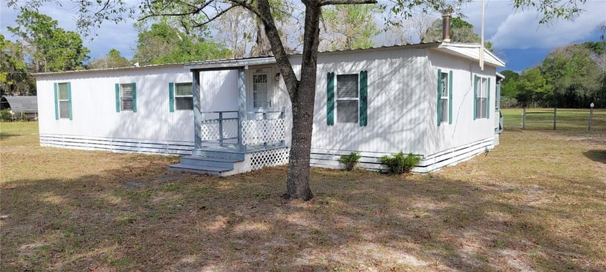 This 3 bedroom, 2 bath, furnished mobile home in desirable Homosassa, FL sits on a spacious 1.89 acre site, fully fenced and cross-fenced, ideal for horses. The property features a 1 stall barn with attached run-in shed large enough for vehicle storage, a separate 4 stall barn with electric and water just outside and 2 other storage sheds. Home features spacious eat-in kitchen with plenty of cupboard/counter space and pass through overlooking the living room with gorgeous, woodburning fireplace. Down the hall you’ll find a guest bath with washer hook up, an office, 2 guest bedrooms and a generously sized master bedroom with walk-in closet, full bath and sitting room/flex space with private exit out to the vast back yard. With enough room for an Accessory Dwelling Unit (ADU) this property has great potential for multi-generational living, rental income, or guest house. Approximately 1 hour drive from both Ocala and Tampa and within 3 miles from access to the Suncoast Parkway! Enjoy the peaceful country setting while still being close to local amenities, parks, and outdoor recreation. Call and schedule your viewing today! Previous contract fell through due to buyers home not selling.