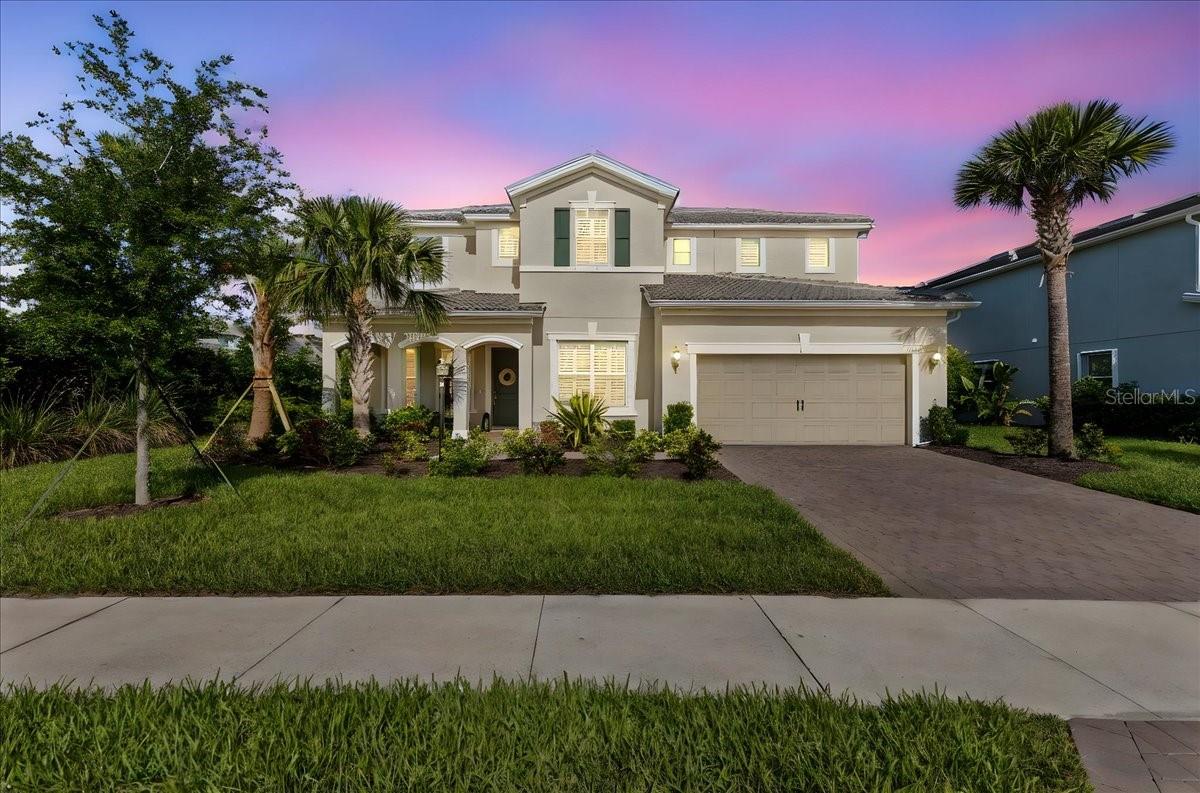 VALUE PRICE/REDUCED! This home lives large at close to 3400 sq feet of AC space! Divosta’s VANDERBILT plan, with 4 Bedrooms, 3.5 baths, flex room (or bedroom 5), formal dining room, butler’s pantry, personal work station, showcases designer finishes throughout, including plank tile flooring, stone countertops, soaring ceilings, accented with crown moldings, 8' interior doors, decorative light fixtures and fans, plantation shutters, all rooms accented in neutral paint. This floorplan is thoughtfully designed with a bright, open concept that perfectly balances modern living with timeless style. The expansive great room features 17ft. of sliding glass doors that seamlessly connect to the screened-in covered lanai and a breathtaking water view! Impressive chef’s kitchen, showcasing a spacious island perfect for family gatherings in the heart of the home, stainless appliances, wall ovens, gas cooktop, a large pantry, the “butler’s pantry” makes dinner entertaining a breeze with additional counter space, a beverage refrigerator and wine storage, prep sink and storage.
The primary bedroom, located on the first floor, features comfort colored paint, plantation shutters, decorative ceiling detail and crown molding. It is spacious and enjoys the water view also, with spa-like bath featuring walk in shower, expansive vanity and storage, along with large walk-in closet. Upstairs, three private bedrooms, all with walk-in closets, two full bathrooms, and a perfect bonus room for that family game room, entertainment or playroom. Step outside and take a breath! The expansive water view is simply beautiful! Screened in lanai for outside enjoyment, spacious back yard with room for a pool. Additional upgrades include designer light fixtures, all interior doors at 8’, plantation shutters, 2.5 tandem garage, gladiator storage racks, an epoxy-coated garage floor, tankless water heater, tile roof, paver drive and patio deck. Mallory Park residents enjoy direct access to Bob Gardner Park and private trails leading to top-rated B.D. Gullett Elementary and Mona Jane Middle. Amenity center offers a Key West-inspired clubhouse with a catering kitchen and event space, fitness center, resort-style pool and spa, fire pit, sports court, and playground..Located in Lakewood Ranch, one of the top master-planned communities in the nation, and easy access to UTC, Waterside, and I-75.