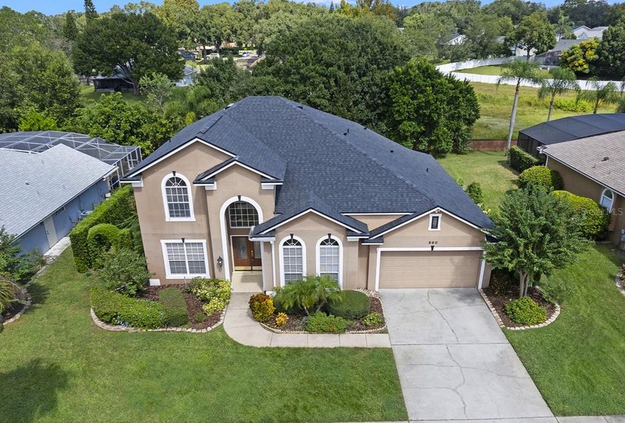 One or more photo(s) has been virtually staged. Located in the renowned Timacuan Golf Community in the heart of Lake Mary. Recently updated with a NEW ROOF, NEW Carrier High Efficiency AC, and NEW carpet! From the moment you enter through the double doors and into the grand 2-story foyer, you'll be impressed by the spacious, light-filled layout, REAL WOOD FLOORING, and CROWN MOLDING throughout every room.  The formal living and dining room provide an elegant space for entertaining. The Living Room is also perfect as an office. **Stylish tile floors lead you to the expansive family room and open-concept GOURMET KITCHEN, which overlooks the sparkling SALTWATER POOL with a Newer variable speed pump and a covered lanai. NO REAR NEIGHBORS create a private oasis.** The kitchen features granite countertops, a center cook island with a downdraft fan, a snack bar, breakfast nook, BUILT IN OVENS, and newer appliances—including a NEW cooktop, NEW dishwasher, and Newer refrigerator (2 yrs).**The luxurious primary suite is located on the first floor with views of the the pool and backyard. The Master boasts NEW CARPET, volume ceilings, an expansive walk-in closet, soaking tub, dual vanities, and a separate shower. Next to the Master is the full-size pool bath with an updated vanity top and a tiled shower for added convenience.**Upstairs, you’ll find three generously sized bedrooms, each with crown molding, LARGE CLOSETS, and plenty of natural light. A LARGE LOFT provides flexible living space, while the thoughtfully designed Jack and Jill bathroom includes two separate sink areas and a shared shower separated by 2 doors for added privacy.**Additional highlights include DOUBLE PANE WINDOWS, NEWER SLIDING DOORS in the family room & kitchen, wooden blinds, ceiling fans in nearly every room, crown molding throughout, and lush landscaping with an irrigation system.**This immaculate home offers comfort, functionality, and style—all in a prime location and with a NEW ROOF for peace of mind.  Don’t miss your opportunity to own this exceptional property in one of Lake Mary’s premier golf course communities! ** Check out the Virtual Tour Link for a 3D walking tour!