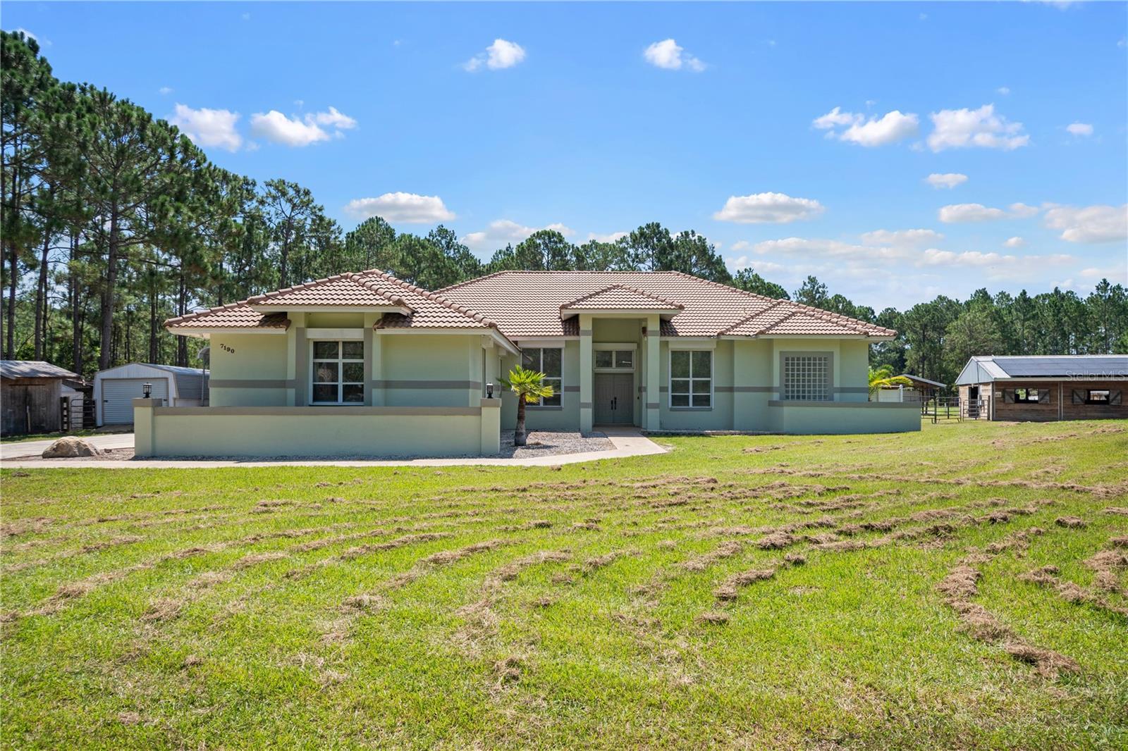 A rare opportunity to own a beautifully maintained 4-bedroom, 3.5-bath equestrian estate with a dedicated office in the highly sought-after Bay Lake Ranch community. Offering 3,210 sq ft of living space and set on 5.4 acres—with over 2 acres fully fenced—this property provides exceptional privacy, featuring only one neighbor and surrounding sides that cannot be built on.
Perfectly suited for a variety of animals, including horses, ponies, chickens, and cows, this estate features a 7-stall barn with a stall grid drainage system for easy cleaning, a dedicated electric panel with water and lighting, a 35’ x 35’ hay storage building, exterior stalls, a chicken coop, pond, supply shed, carport, and multiple outbuildings ideal for storage, equipment, or workspace.
The home is powered by 53 fully owned solar panels, providing enough energy to efficiently run the entire property. Additional upgrades include a tile roof, full-property security camera system, and hurricane roll-down and electric shutters on all large sliders and windows for added safety and peace of mind.
The outdoor living area is perfect for entertaining, featuring a private pool, a spacious concrete patio for seating, a wet bar, and a separate pool bath entrance. Combining the charm of country living with modern efficiencies and unmatched privacy, this move-in-ready estate is a truly unique opportunity in one of the area’s premier equestrian-friendly communities.