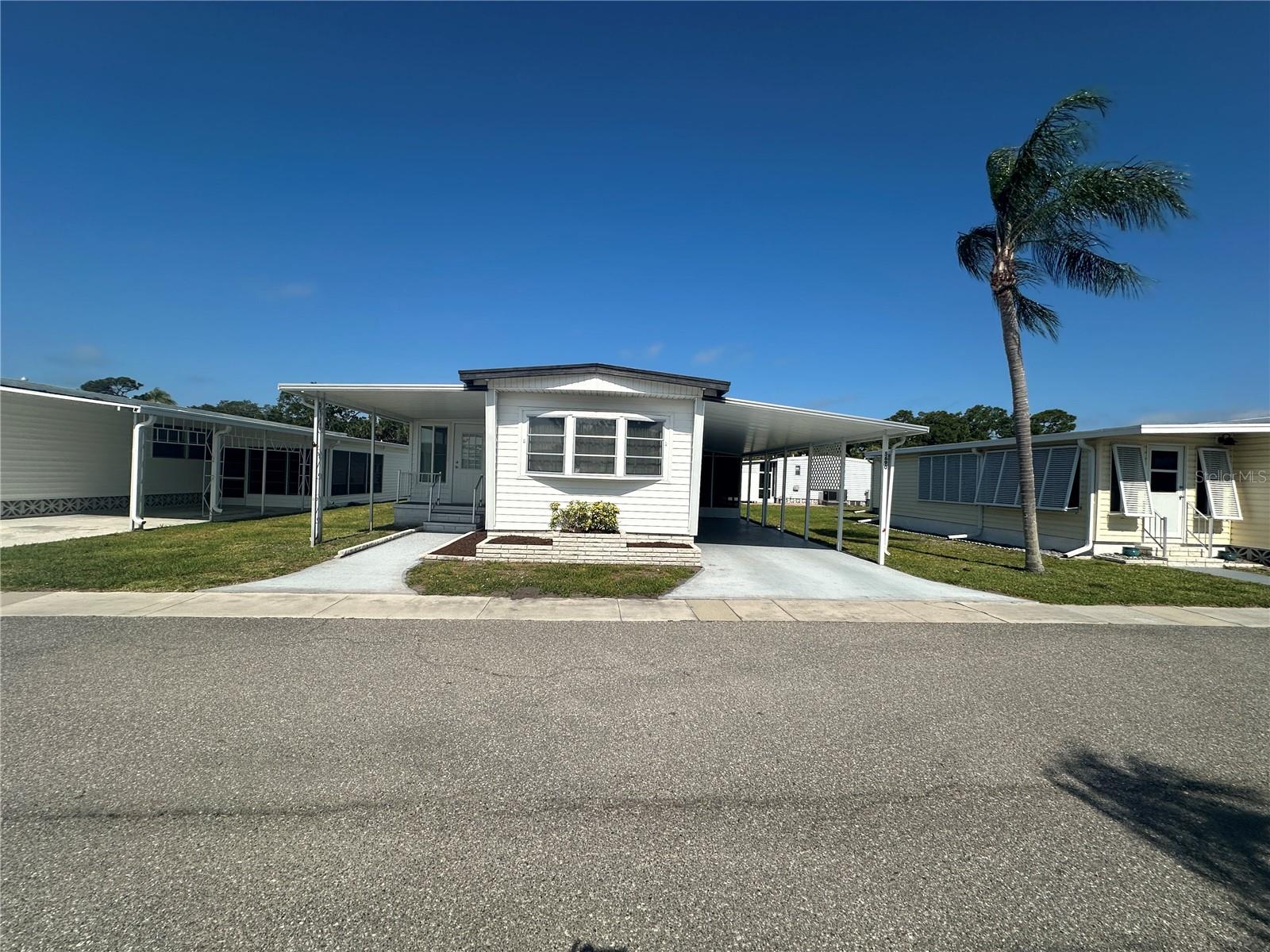 Two bedroom, two bathroom in Beautiful Japanese Gardens! Japanese Gardens is an active 55+ community in Venice. It is the perfect location! Close to Manasota Beach, downtown Venice, and downtown Englewood. This home has a popular split floorplan with an open concept in the kitchen and living rooms. The Florida Room has been opened to the home and adds additional living space, about 170 SF! The home has laminate flooring throughout. The split floor plan and guest bedroom with private bath is perfect for family and friends visiting. There is a large screened lanai with vinyl windows to enjoy the beautiful Florida weather. The oversized shed houses the washer and dryer with extra space for a workshop.